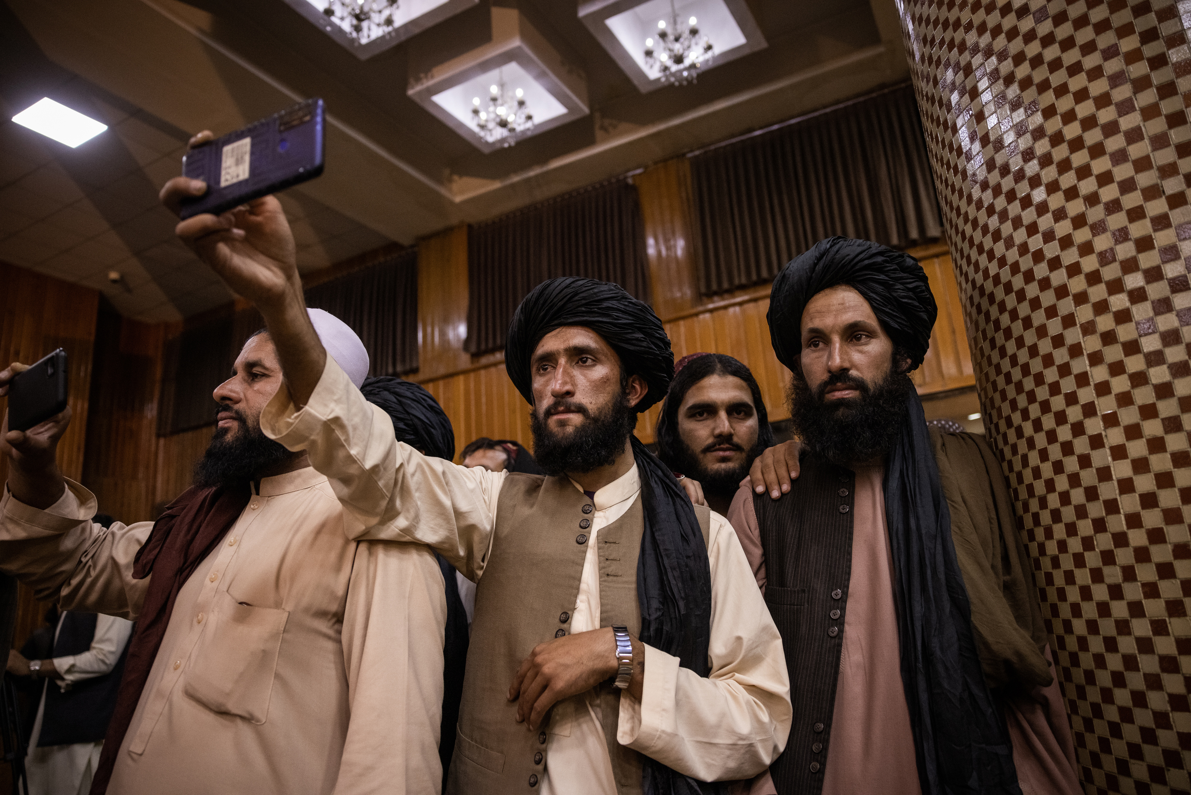Members of the Taliban filmed the first news conference after they took control of Kabul on Tuesday.