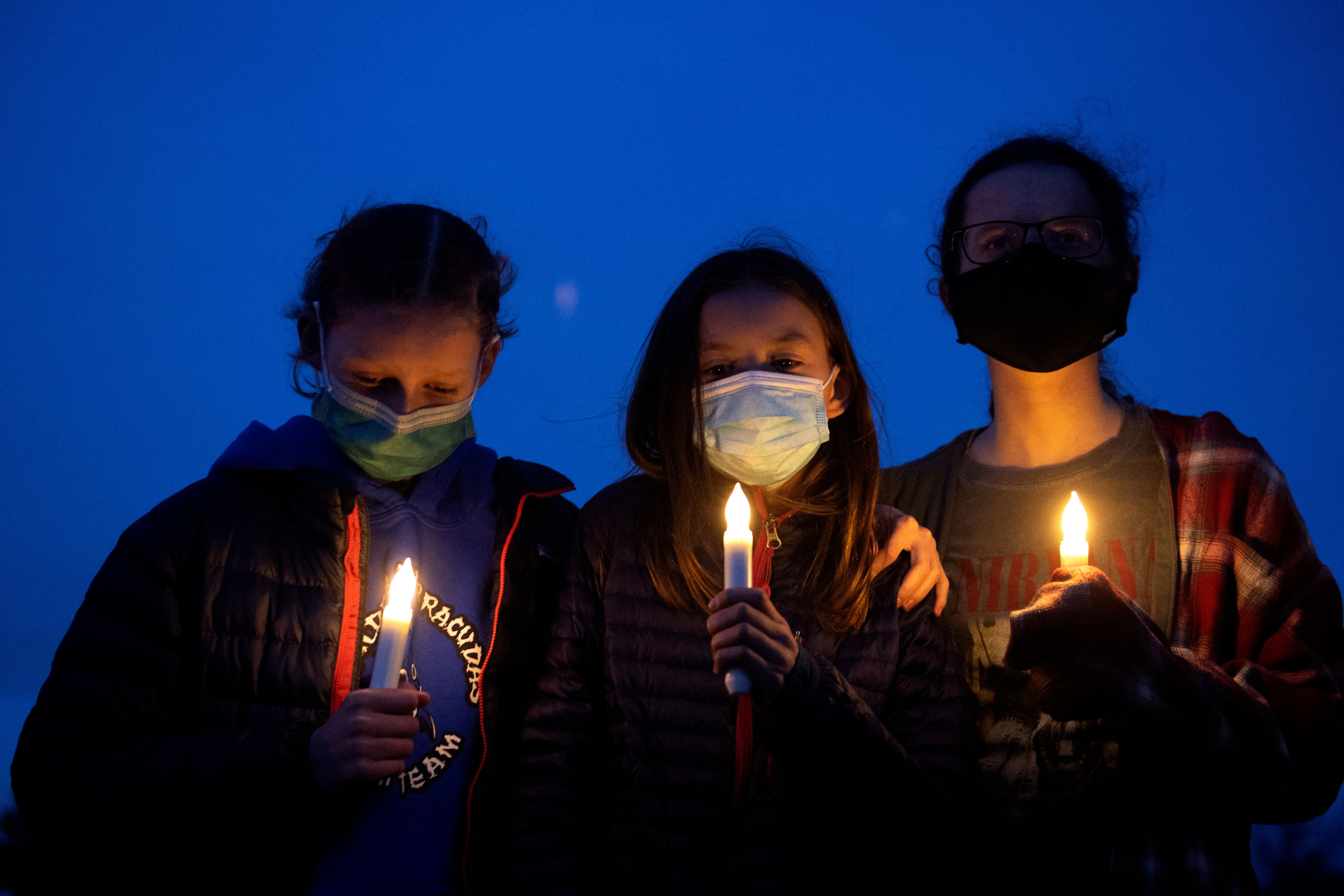 People gathered for a candlelight vigil on Tuesday to honor the ten victims of a mass shooting that occurred a day earlier at a King Soopers grocery store in Boulder, Colo.