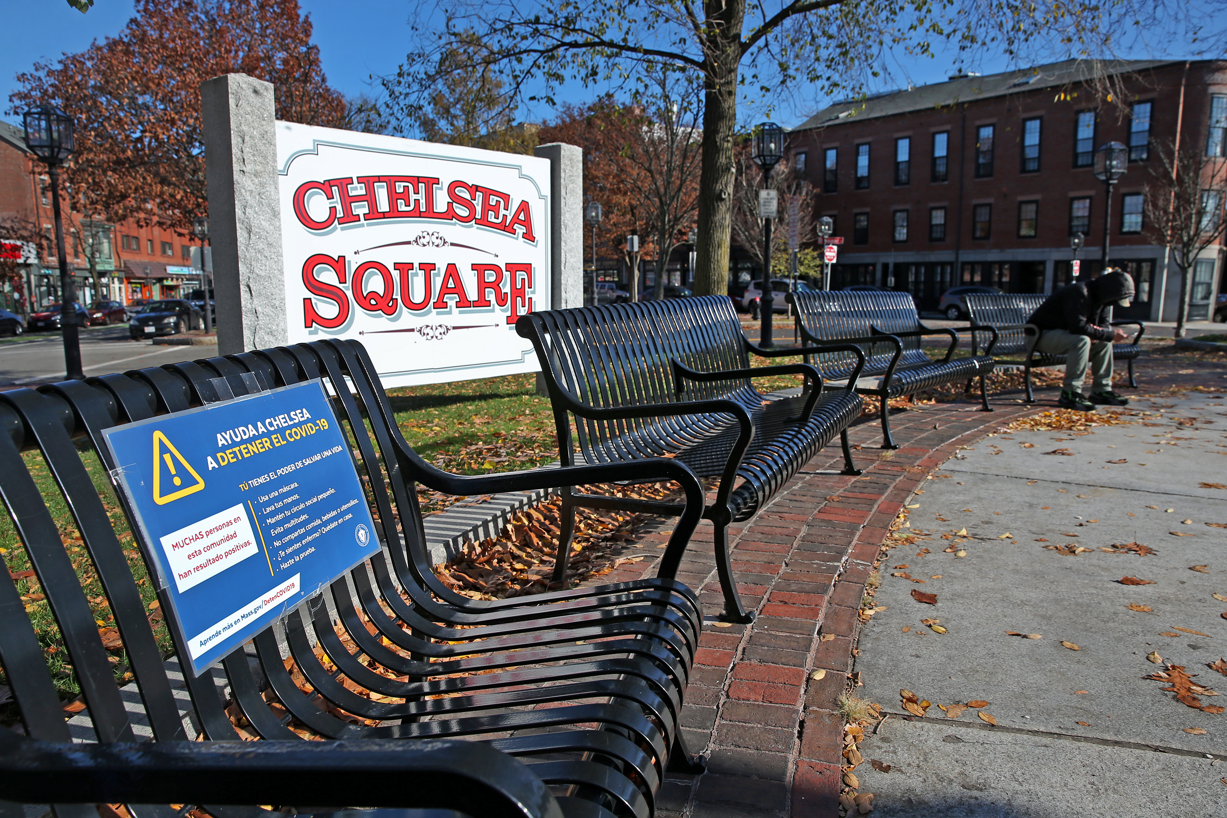 A COVID posting on a bench in Chelsea Square.