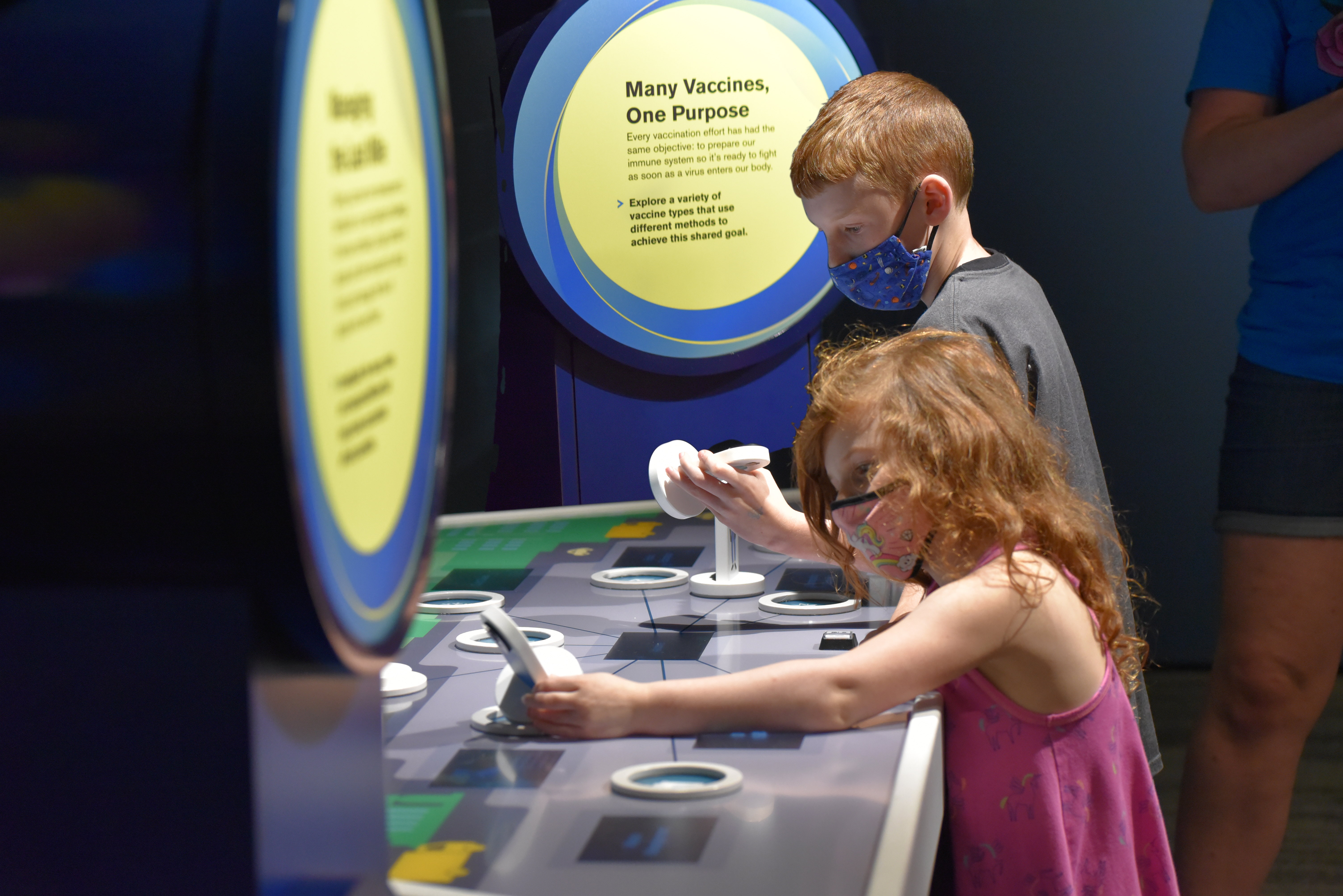 In "Managing the Last Mile," an activity in the Museum of Science's exhibit on vaccines, participants can learn about the people who contribute to a vaccine's distribution, including community organizers and truck drivers.