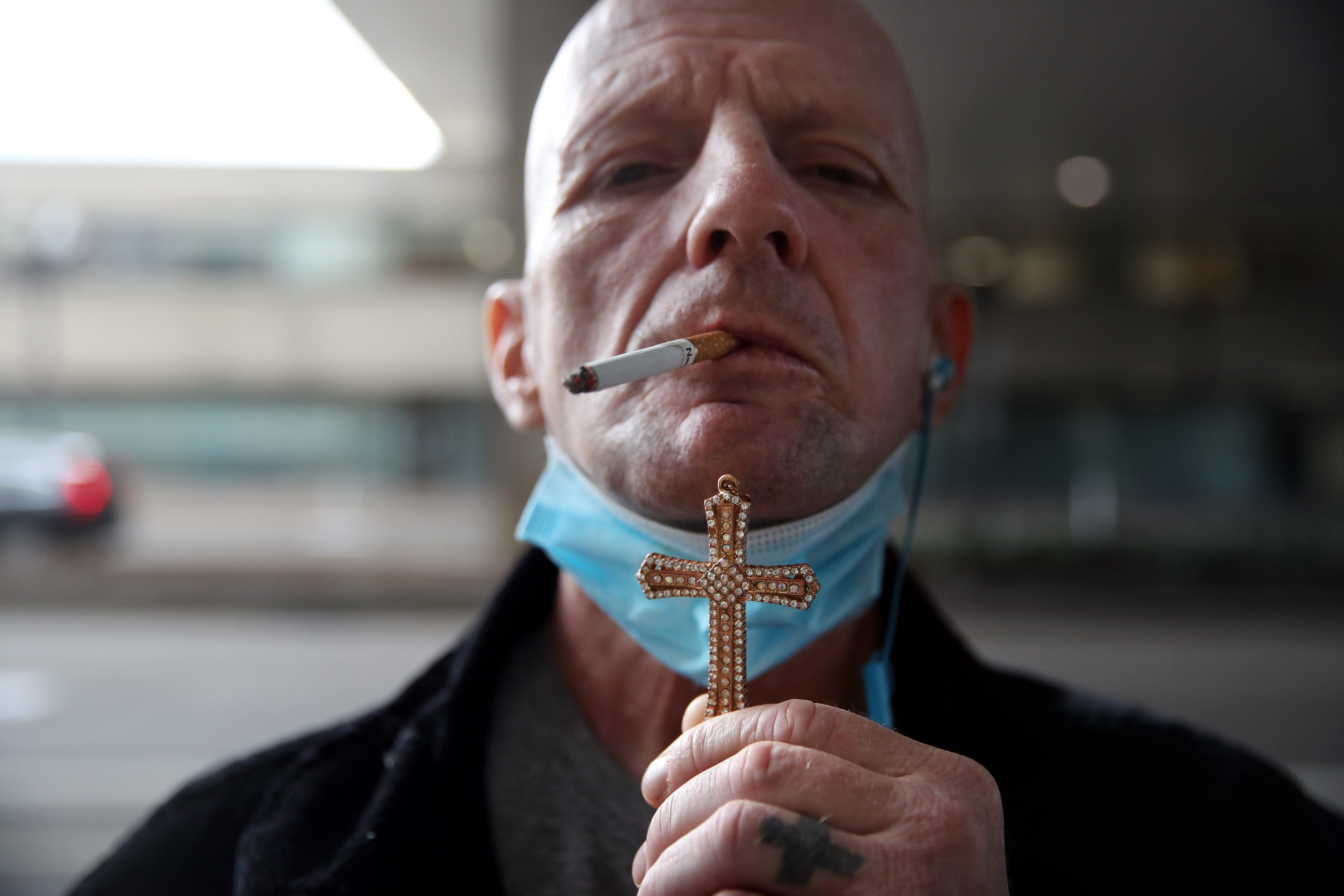 Billy Powers displayed a cross he had found earlier in the day near the intersection known as Mass. and Cass. "I'm faithful but not faithful enough," he joked. He said he recently got an apartment after living on the street for four years.