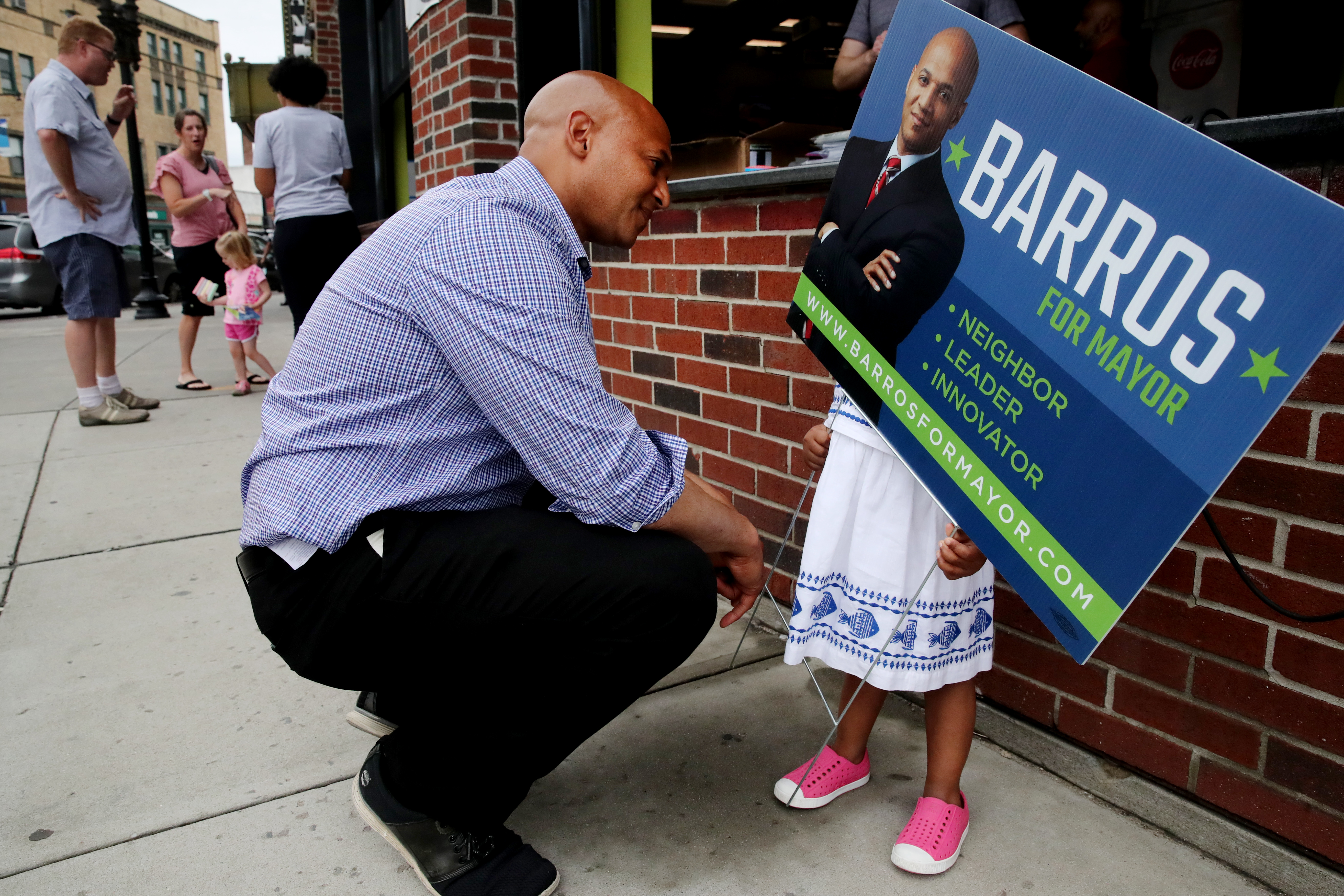 Mayoral candidate John Barros talked with his daughter Olivia during a campaign event outside Boston Pizza and Grill in Dorchester.