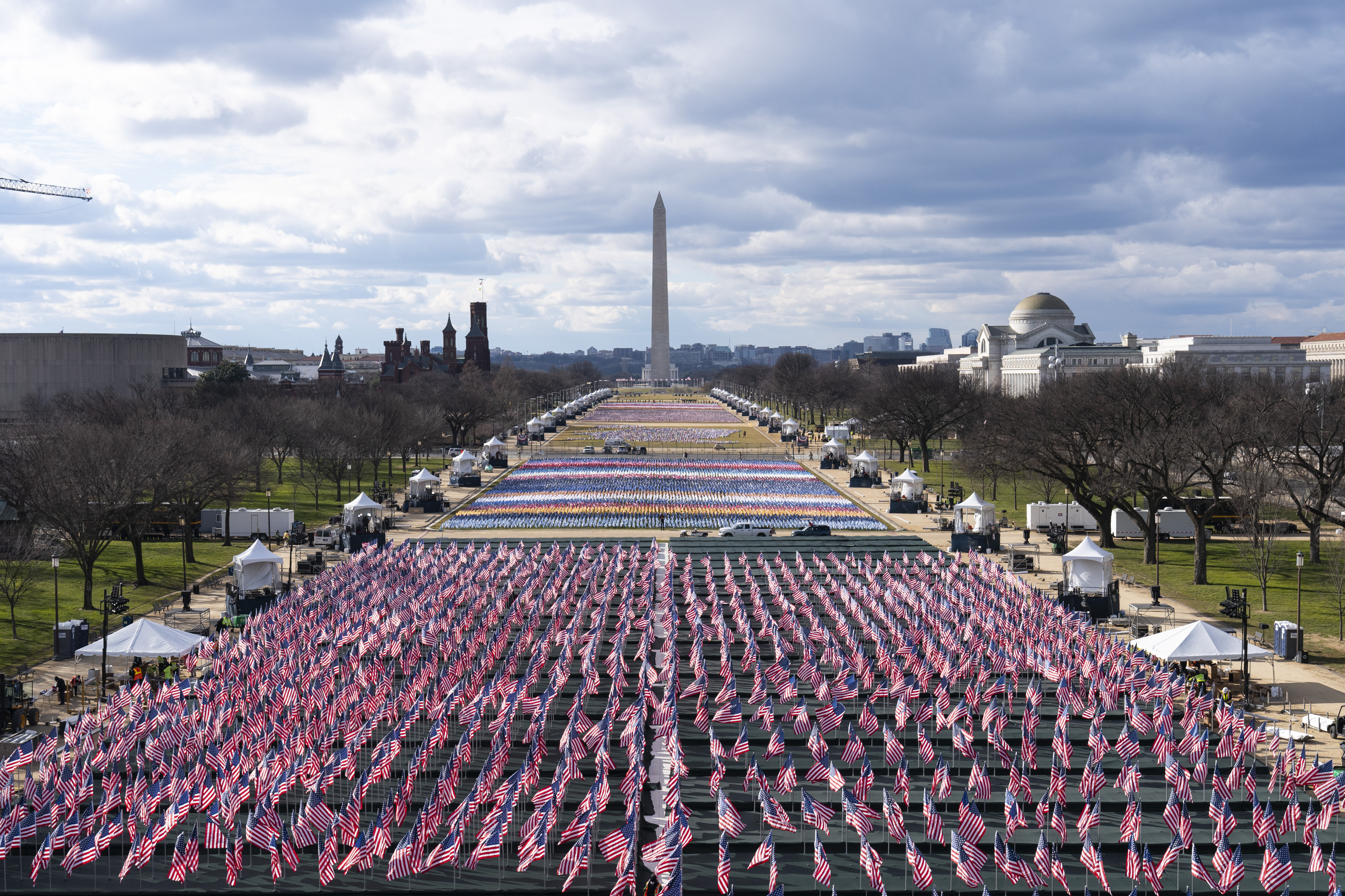 Flags are placed on the National Mall, looking towards the Washington Monument, and the Lincoln Memorial.