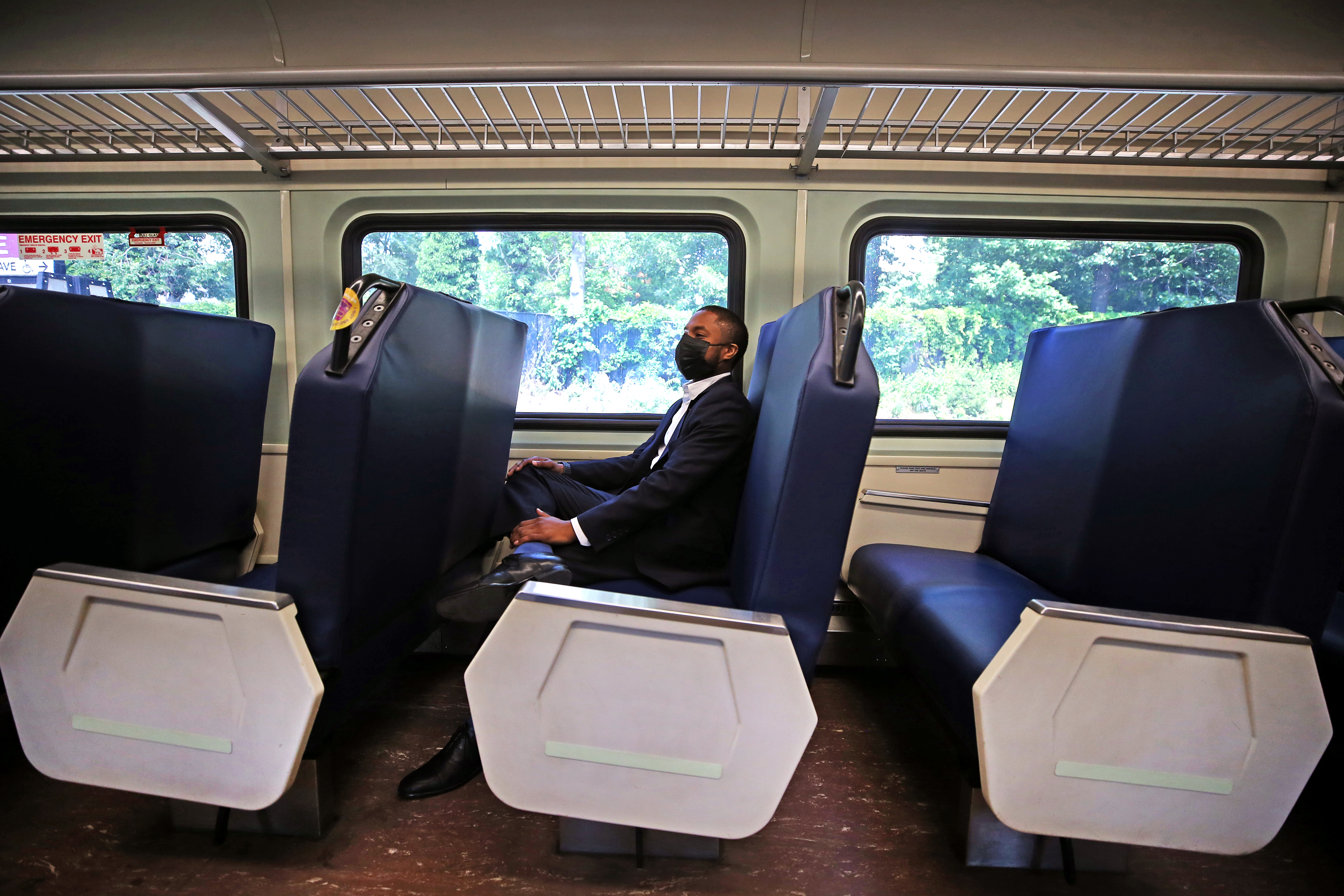 Devin Edwards of Boston waited the required 15 minutes of observation time after getting his COVID-19 shot seated onboard the train.