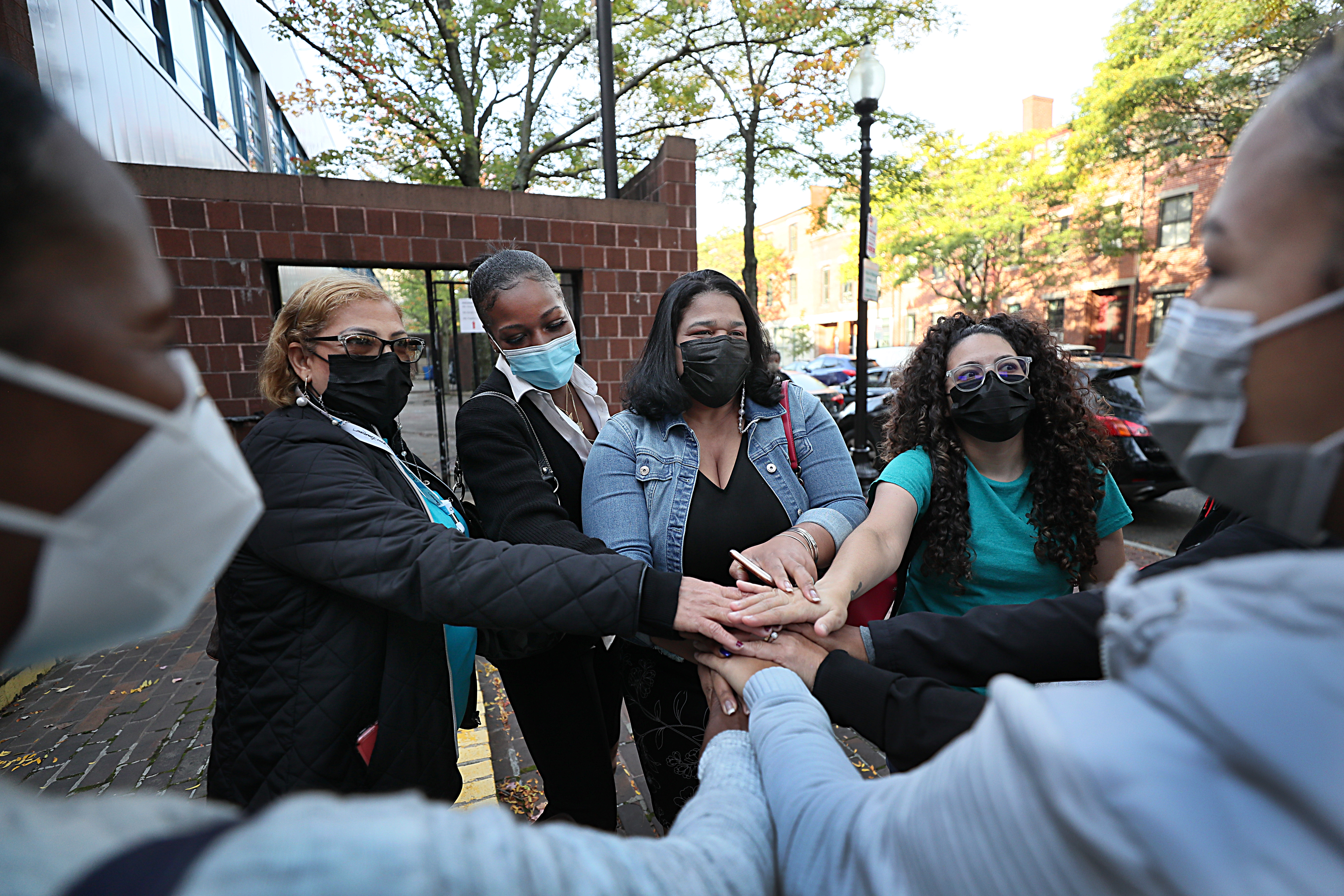 Rafaela Polanco (center, in light blue jacket) greeted women at the Blackstone Elementary School.