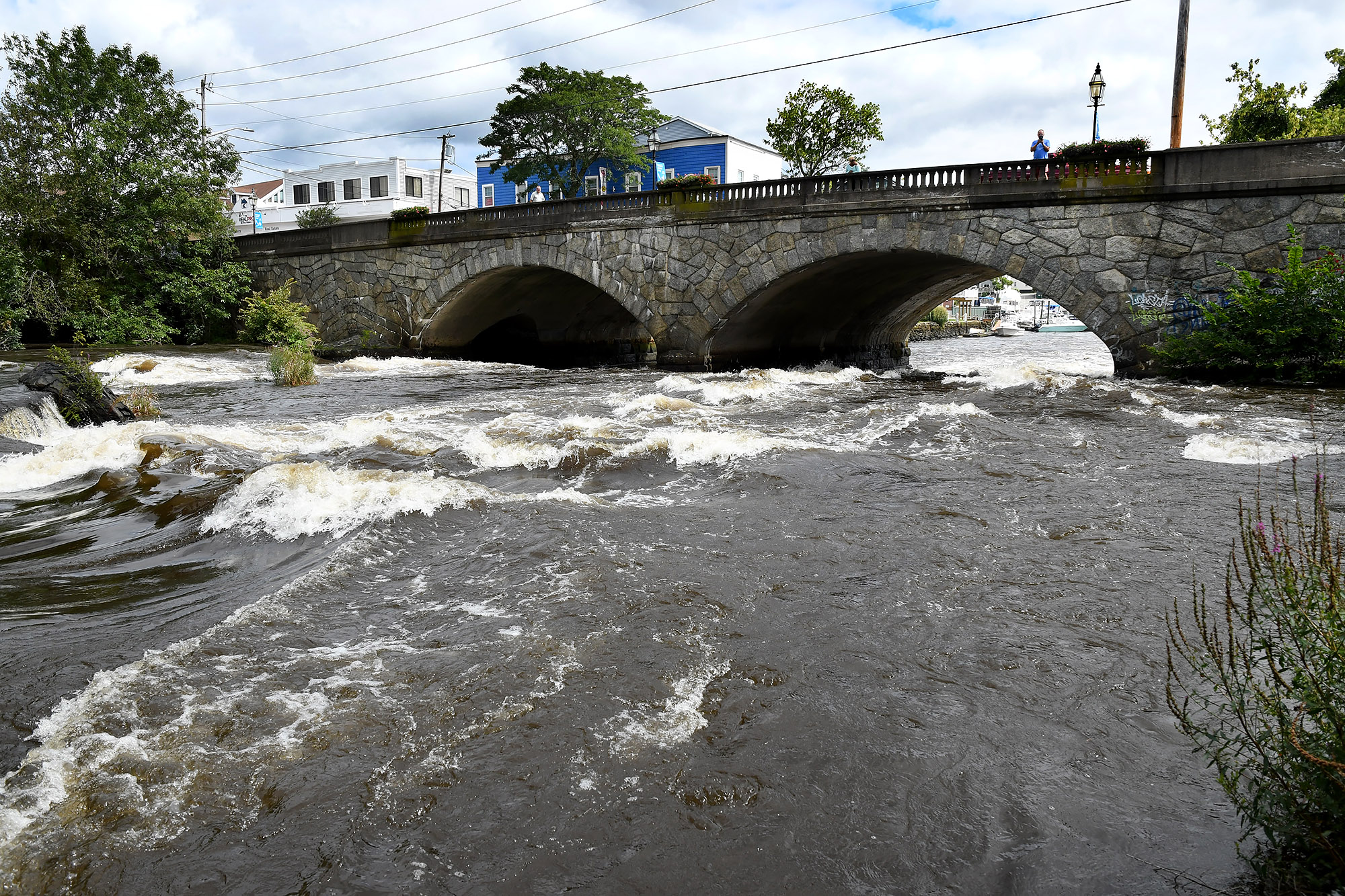 The raging waters of the Pawtuxet River from the Pawtuxet River Bridge in Cranston, R.I. on Thursday.
