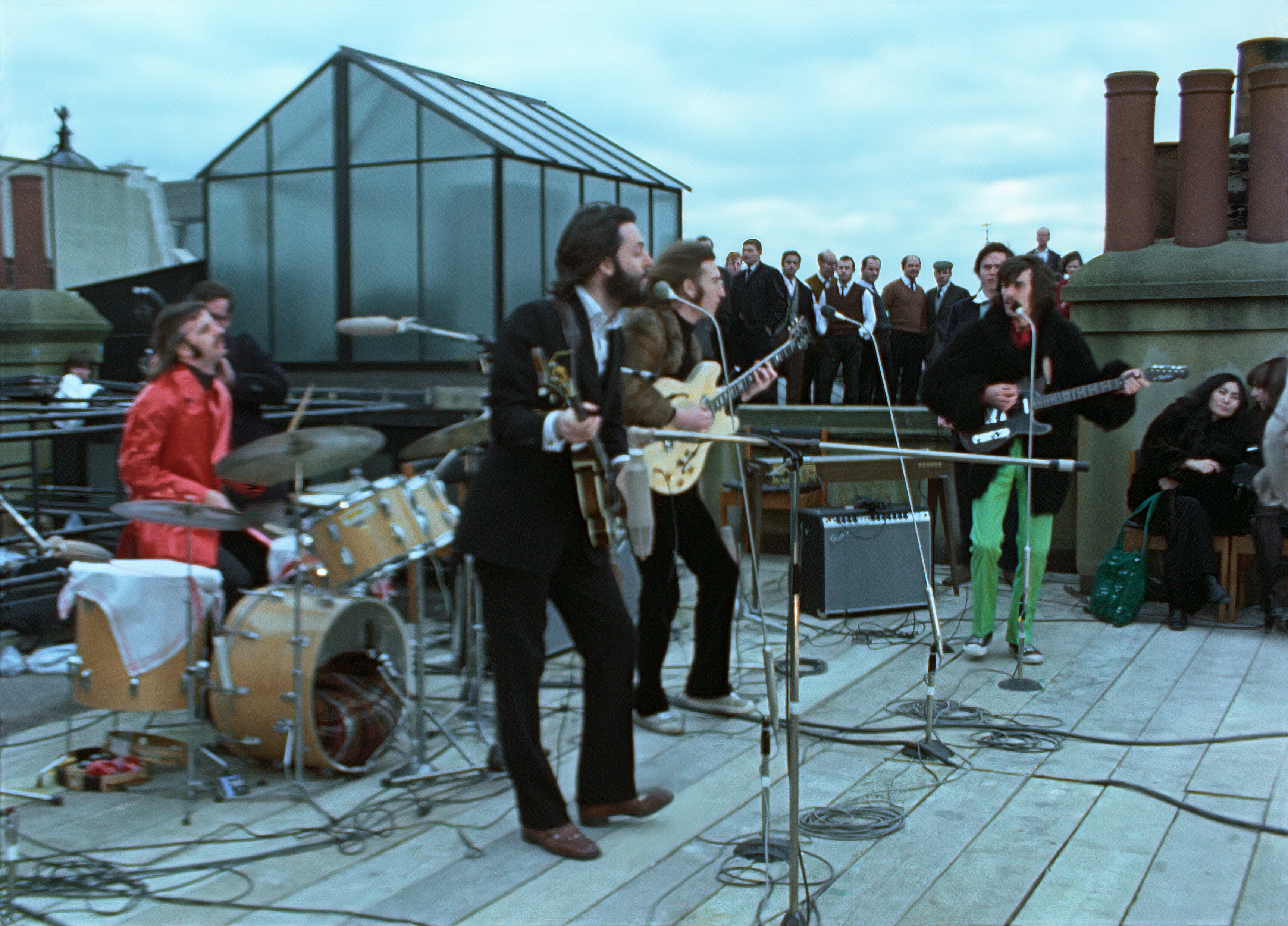 In a picture of "The Beatles: Come Back," the group performs on the roof of Apple Corps headquarters.