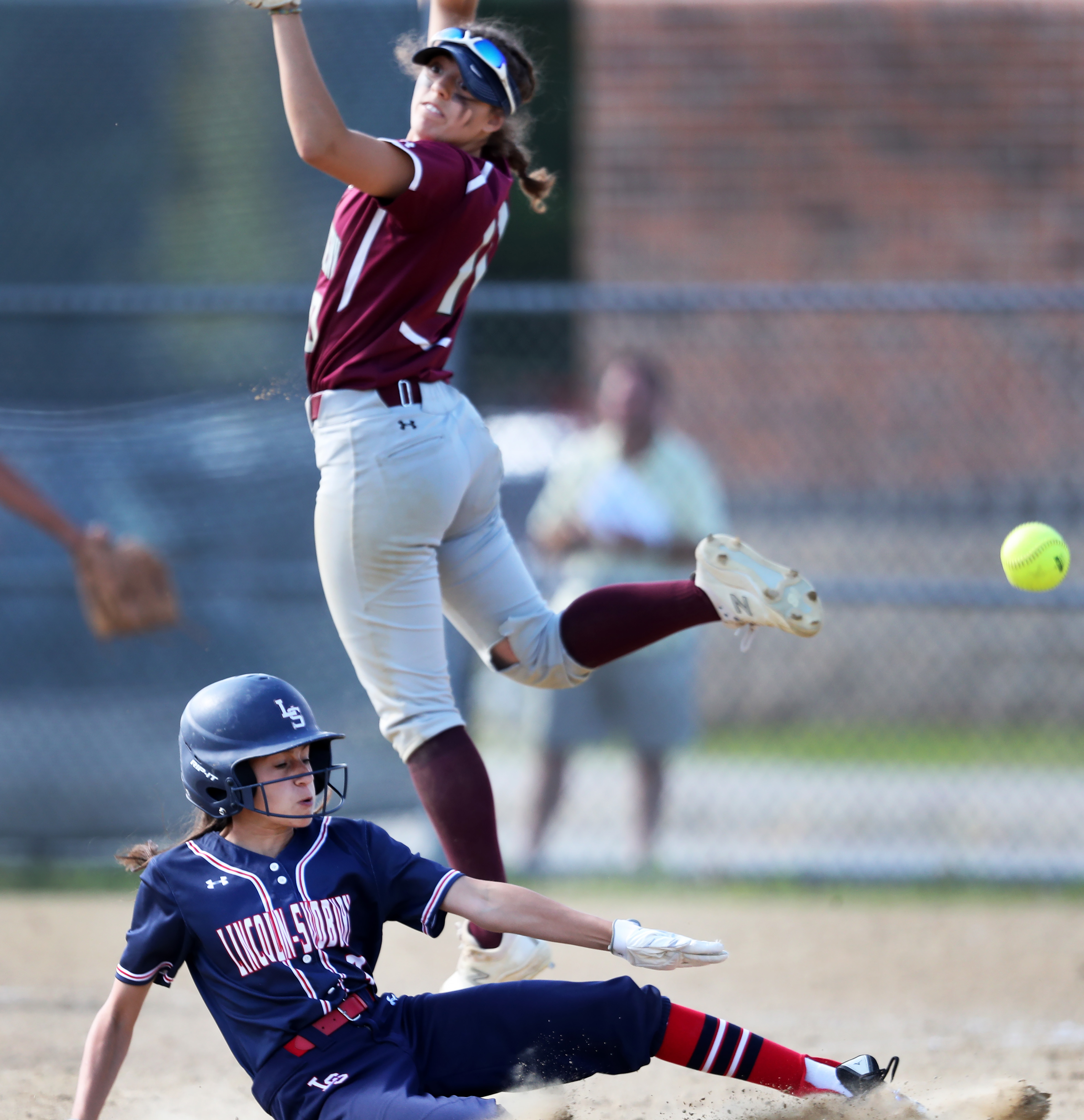 Lincoln-Sudbury's Grace Jorjorian is safe at second with a stolen base as the throw sails over the head of Westford Academy shortstop Kyla Felicani.