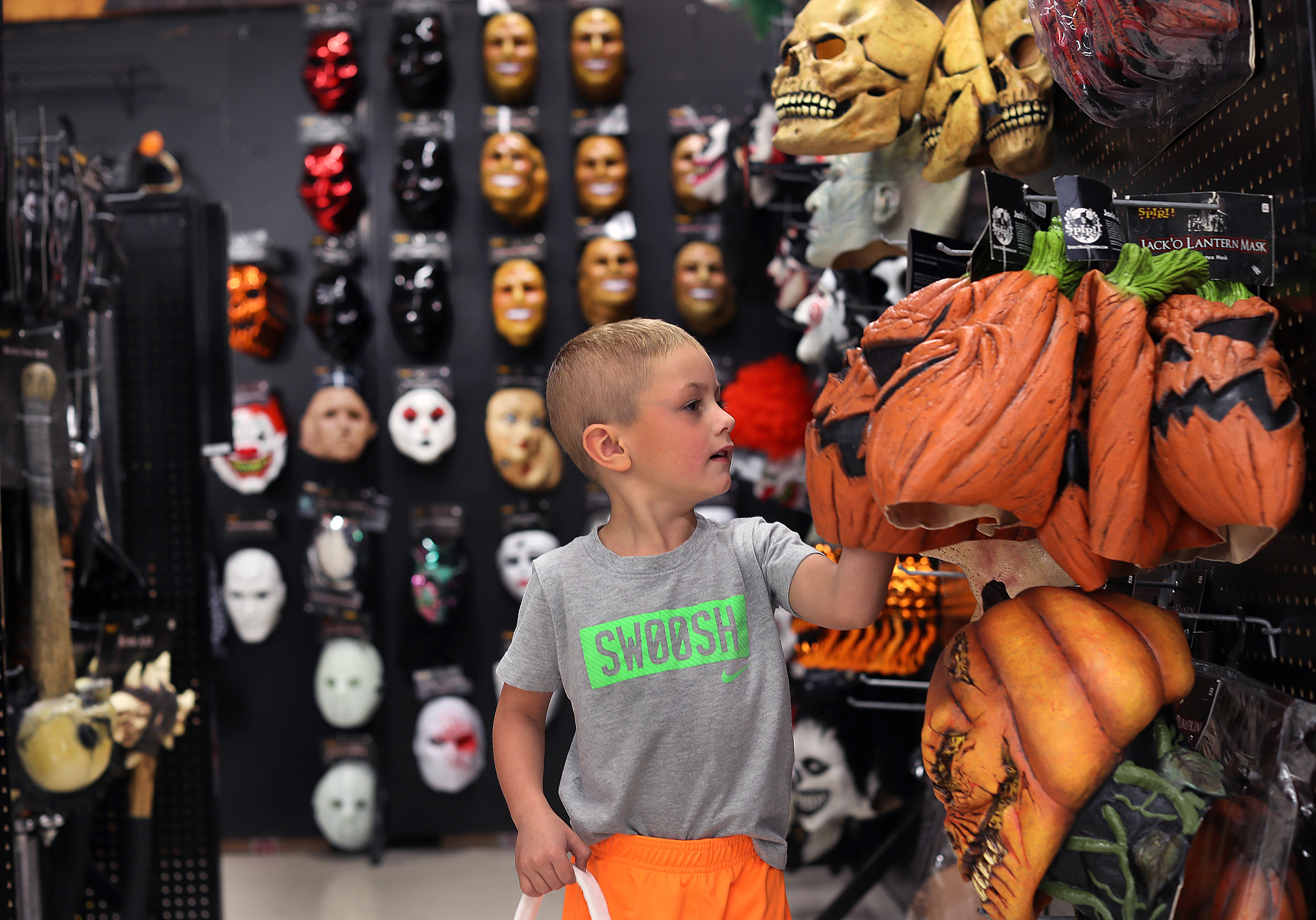 Brady Maloof, 4, of Wrentham looks over some masks.