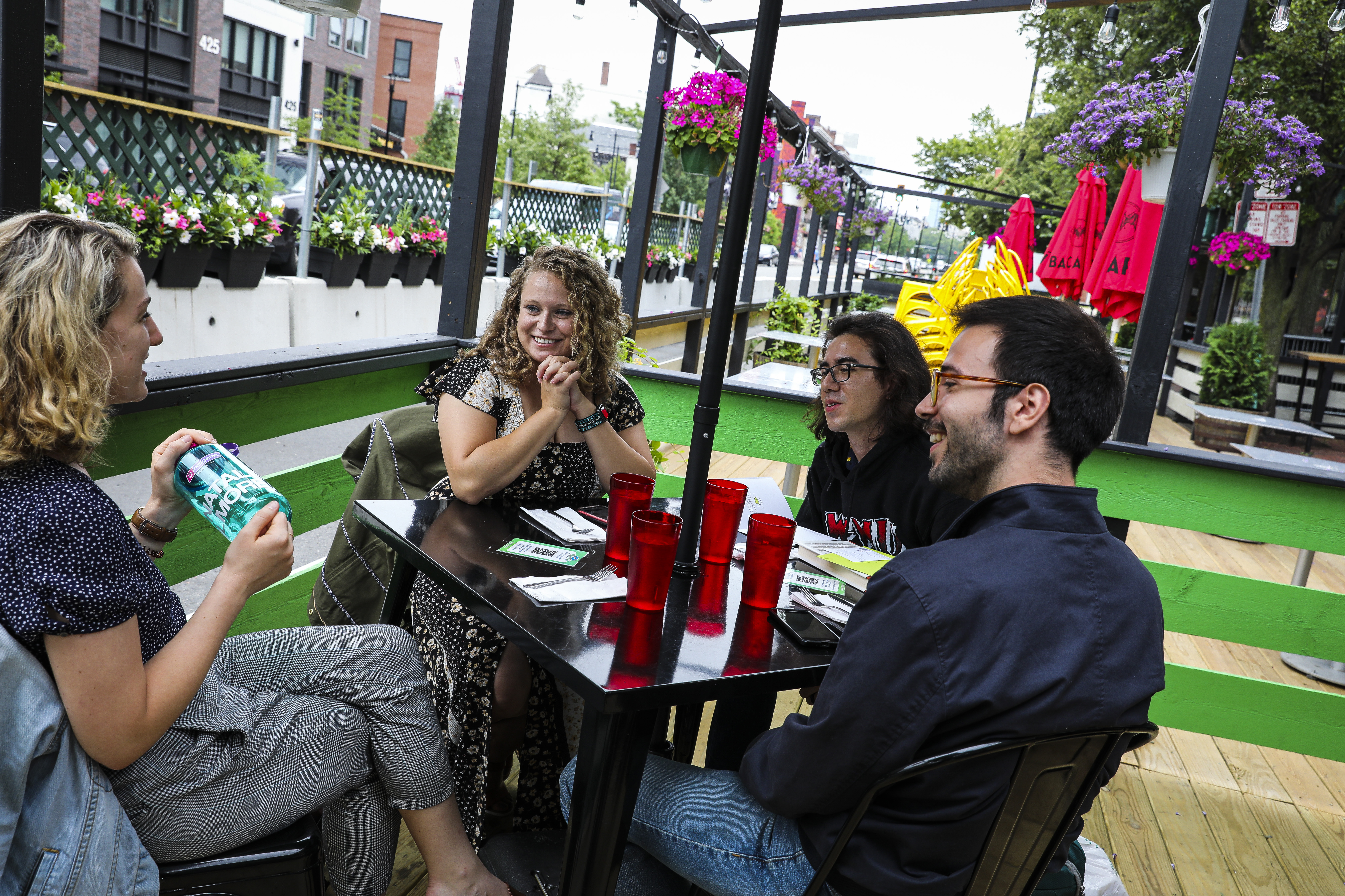 Friends Katrina Ross, Maria Dekhtyar-Miller, David Miller, and Andrew Curreri sat on the patio at Veggie Galaxy on Friday.