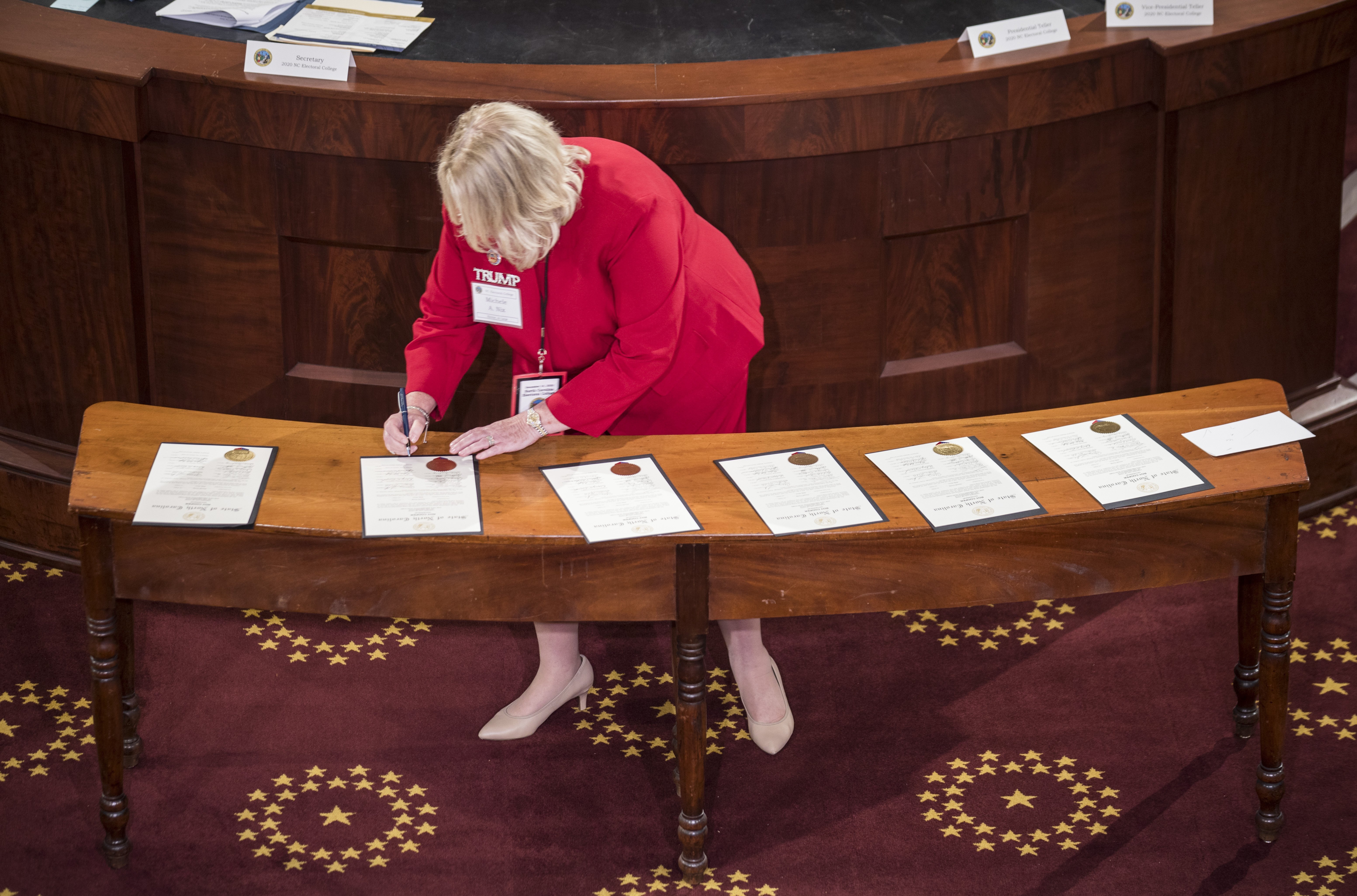 Elector Michele Nix signed Electoral College ballots for President Donald Trump and Vice President Mike Pence in the house chambers of the Old State Capitol building in Raleigh, N.C., on Monday.