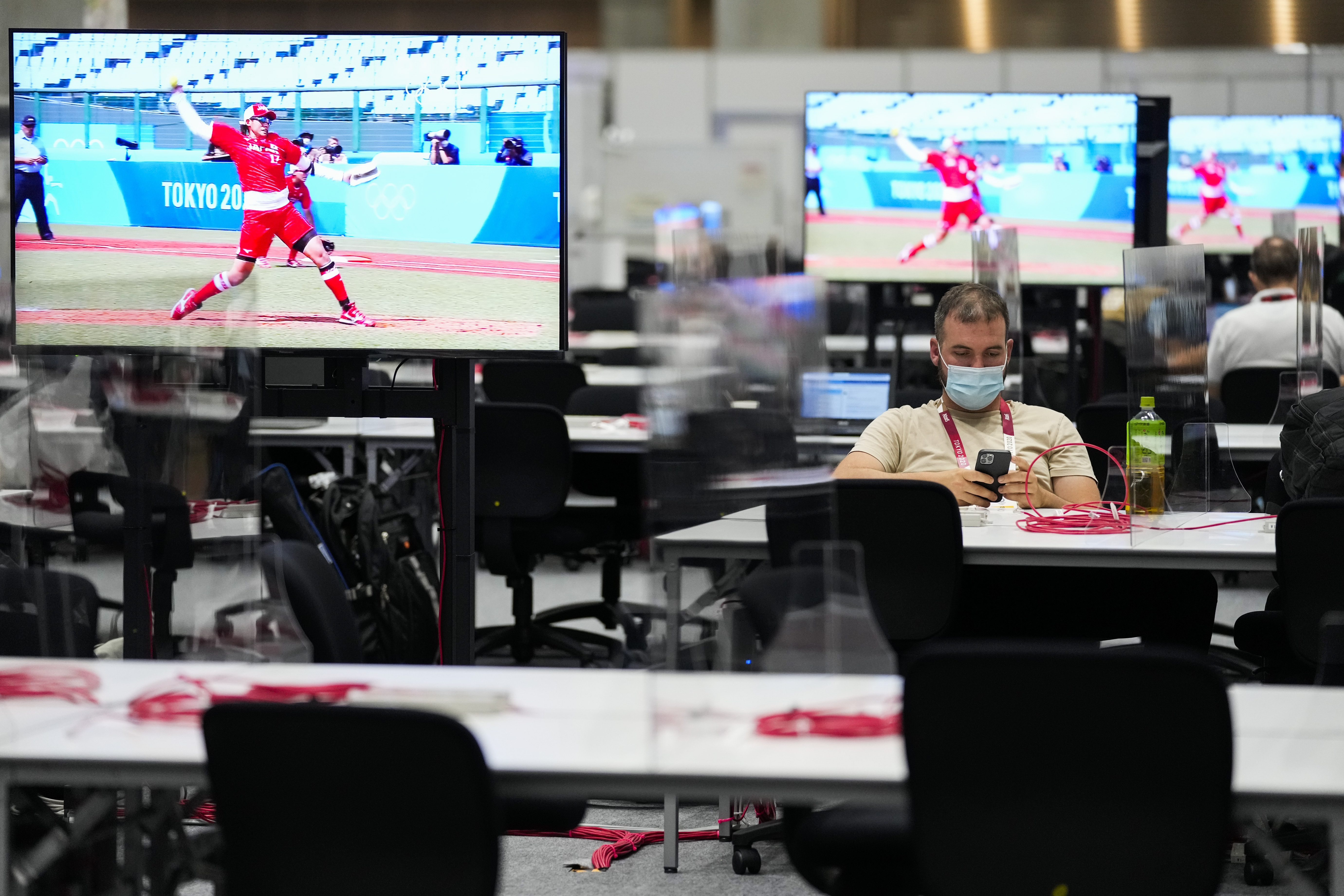 A journalist works in a media area at the Main Press Center Wednesday in Tokyo.