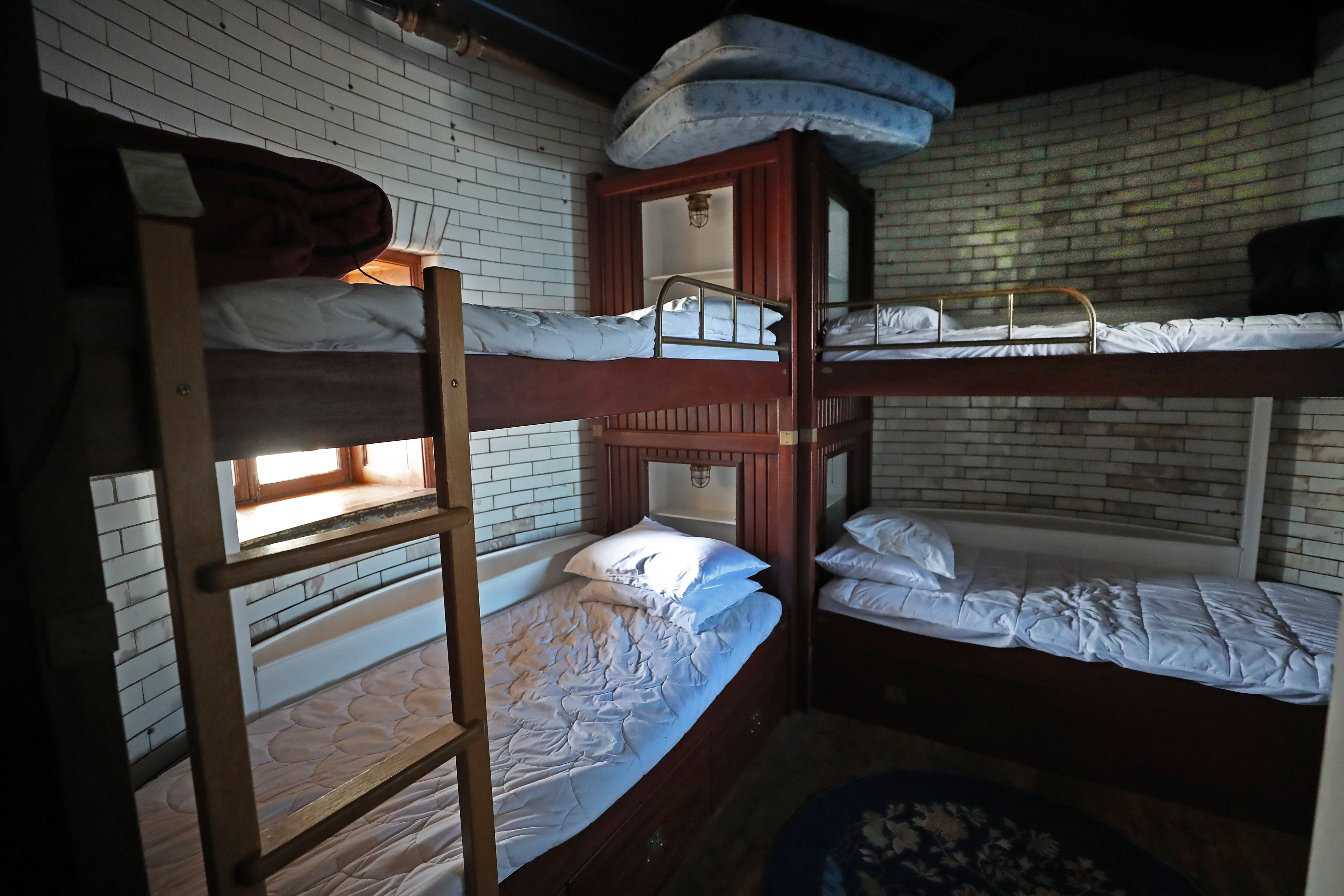 Custom-built bunk berths in a rounded room at Graves Light, the lighthouse that Dave Waller purchased at auction several years ago and has been restoring.