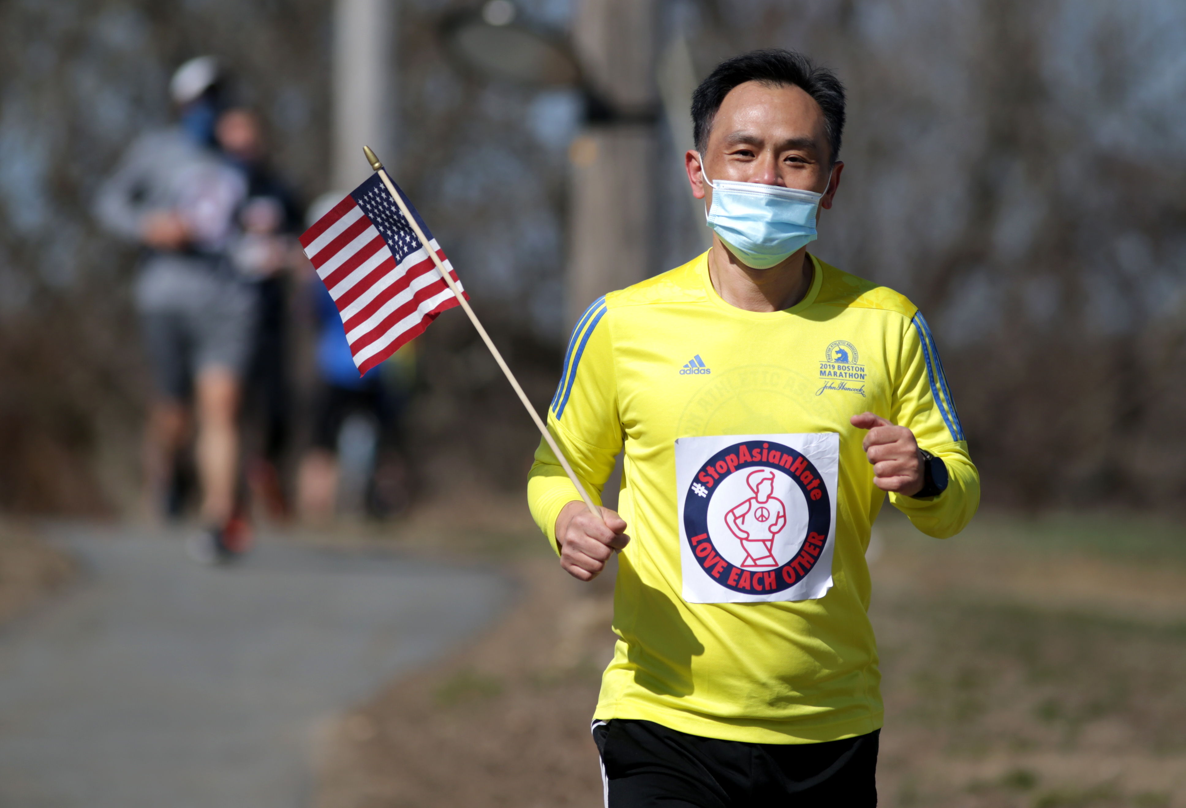 A runner heads through Ashland, as part of the Rally & Run To Stop Asian Hate, and will go through eight cities/towns along the Boston Marathon route.