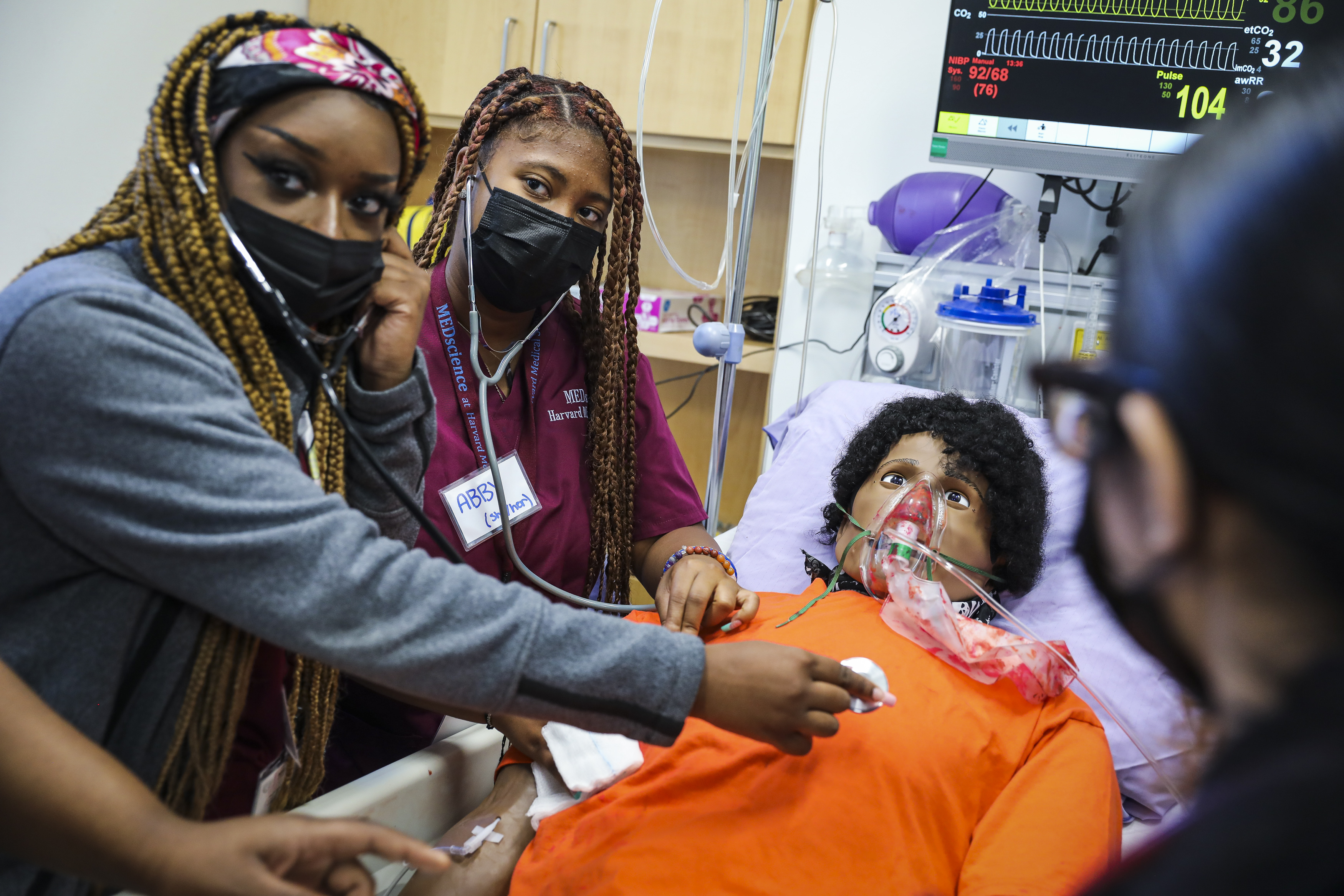 Codman Academy students Isabel McDowall (left) and Abinorah Lauzama work to diagnose a dummy patient during Harvard Medical School’s MEDScience program on Oct. 1.