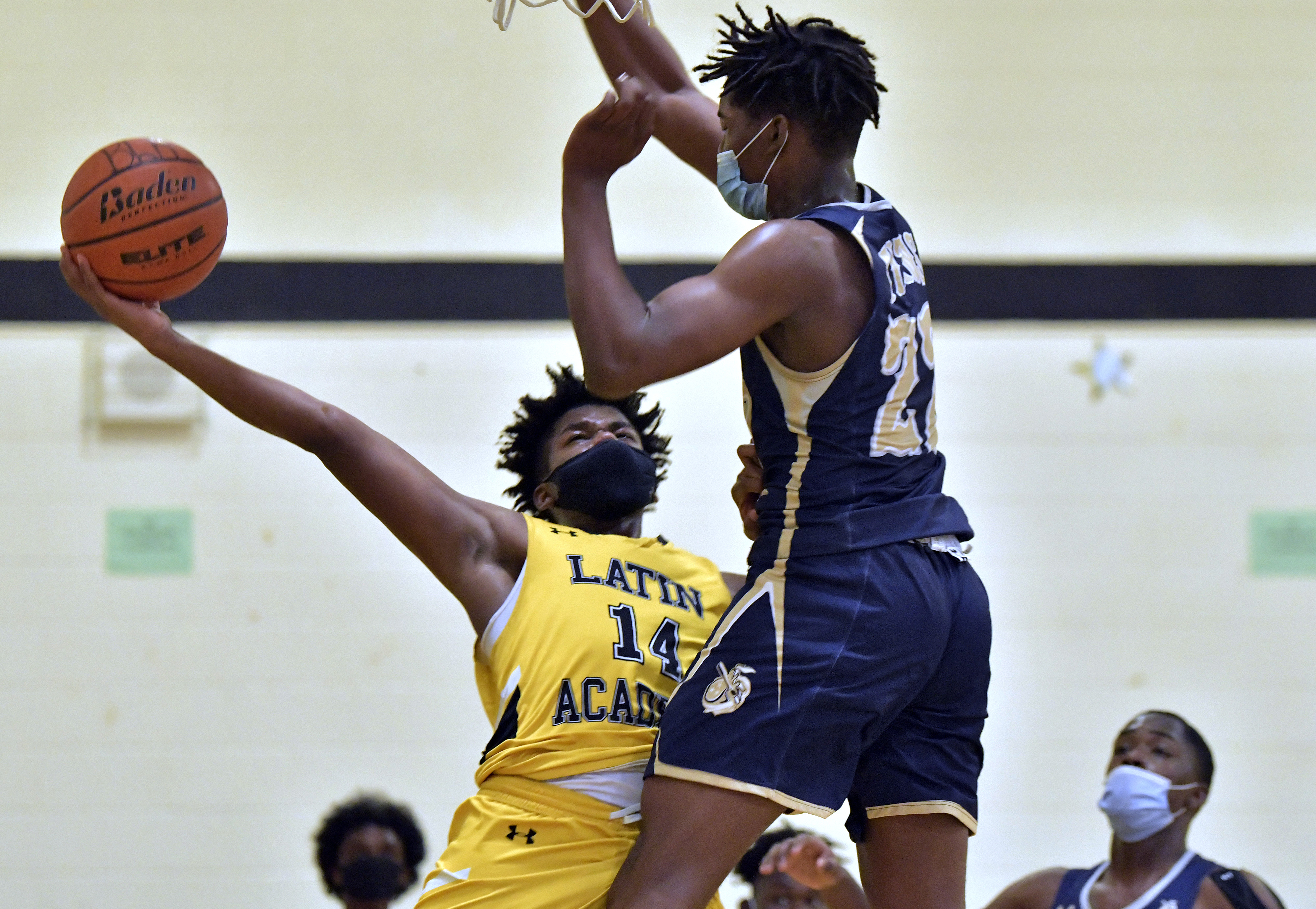 Mason Lawson (14) goes up against the defense of New Mission's Hassan Jenkins (22) during Latin Academy's victory.