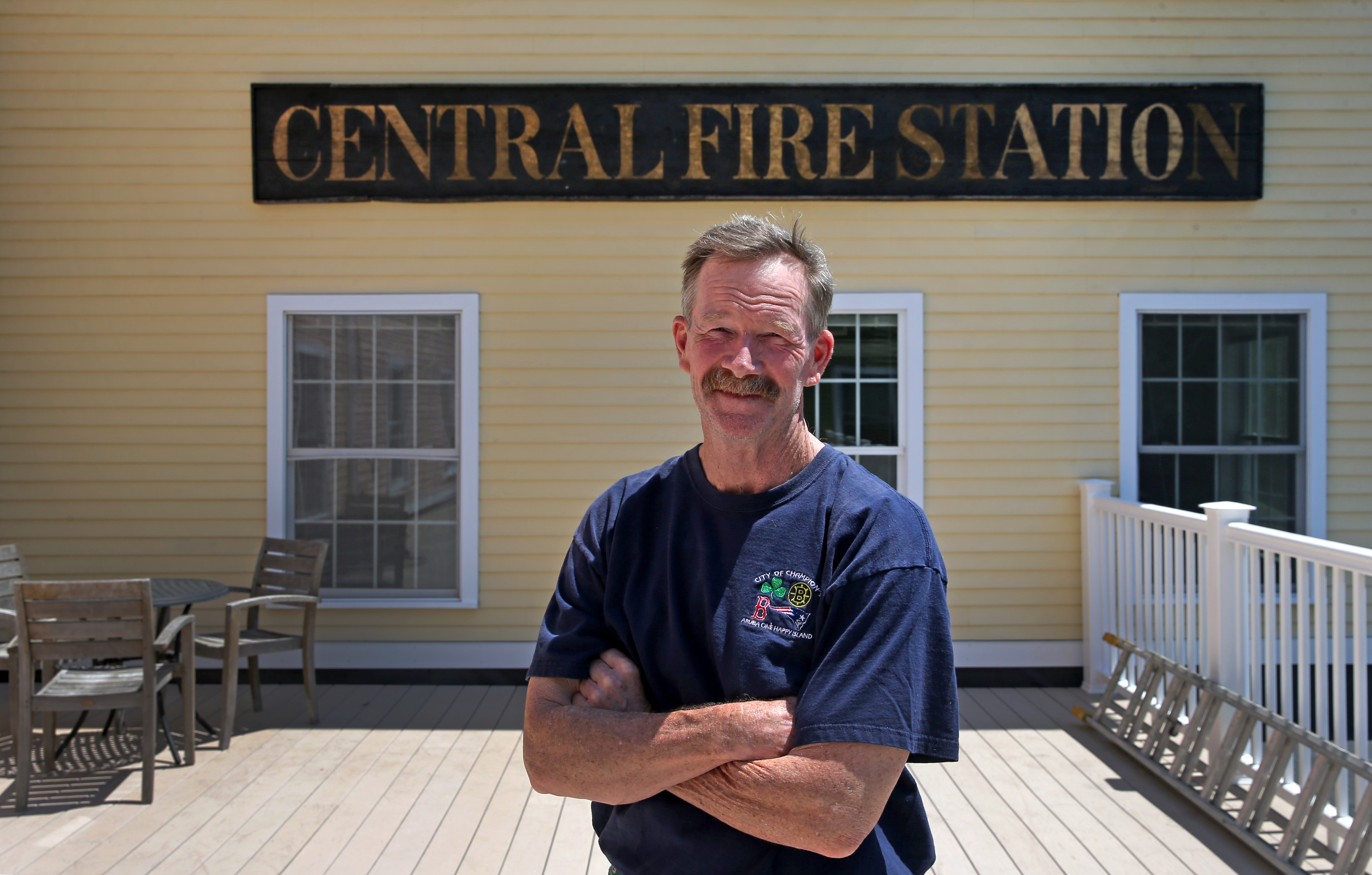 Billy Crosby stands by an antique sign.