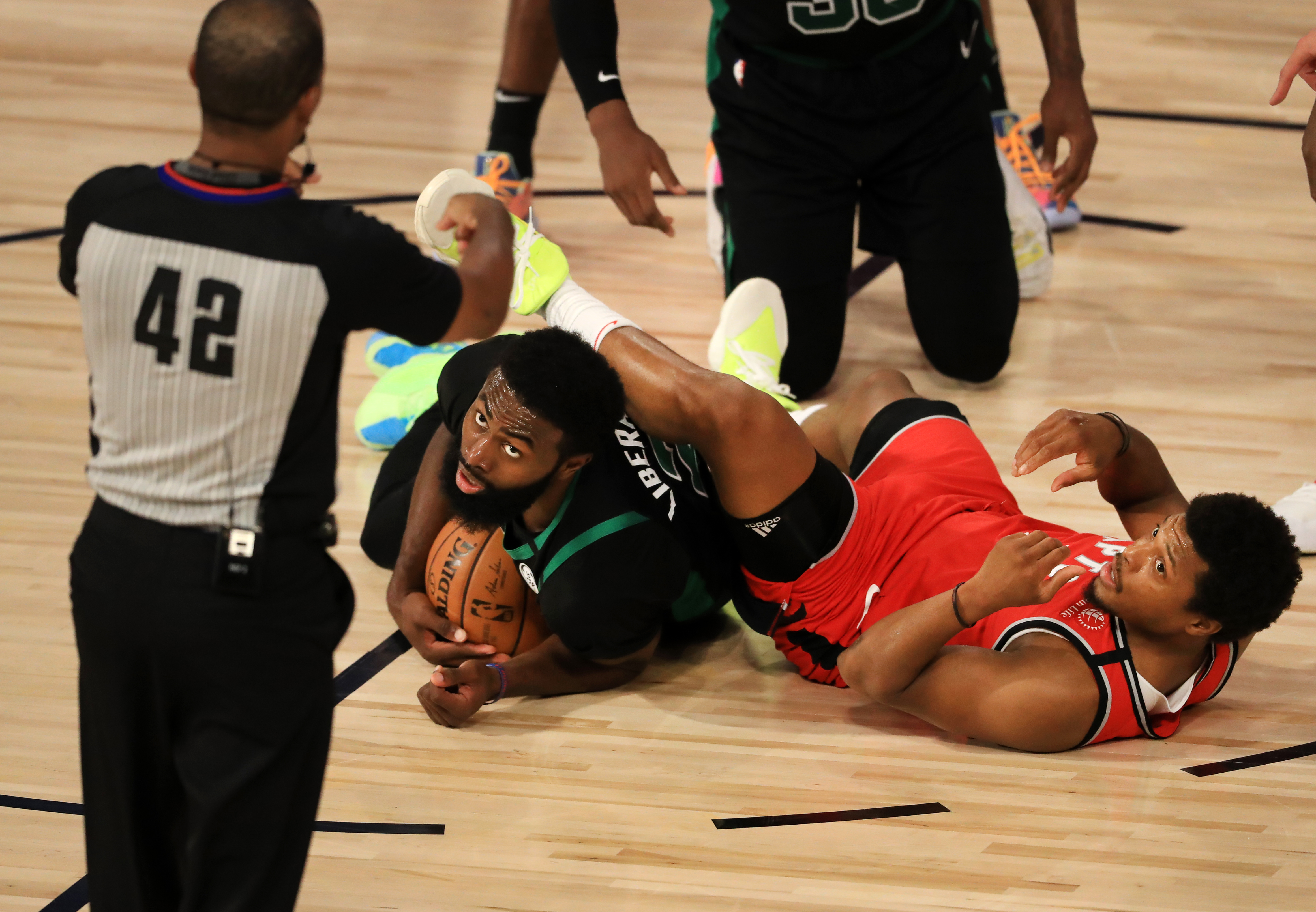 Kyle Lowry and Jaylen Brown wrestle for the ball during the first quarter of Monday's game.