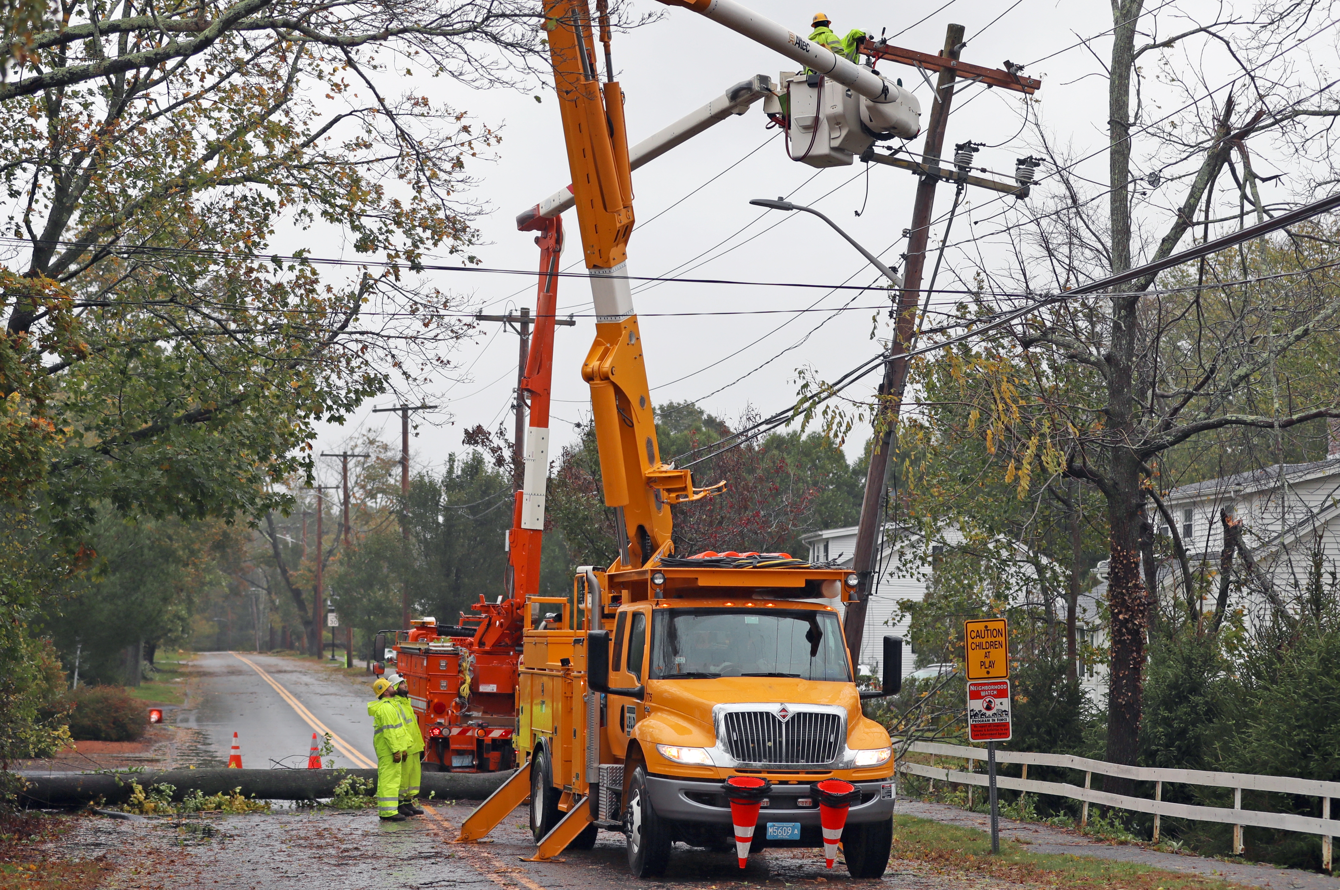 A utility company crew worked on repairs after a tree came down during the storm on Free Street in Hingham.