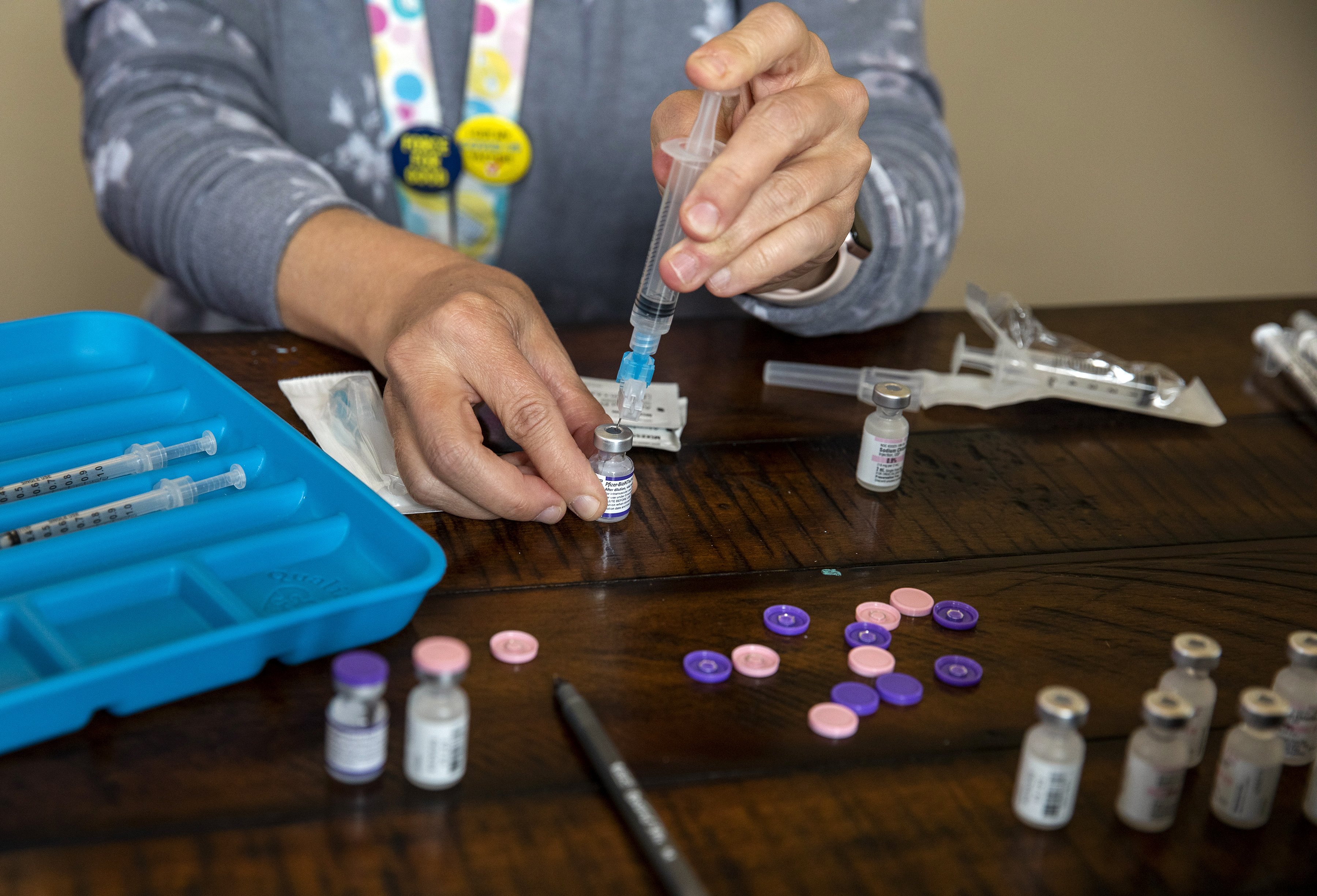 A nurse prepares a dose of the Pfizer COVID-19 vaccine at a mobile vaccination clinic in McMinnville, Ore., on Oct. 6.