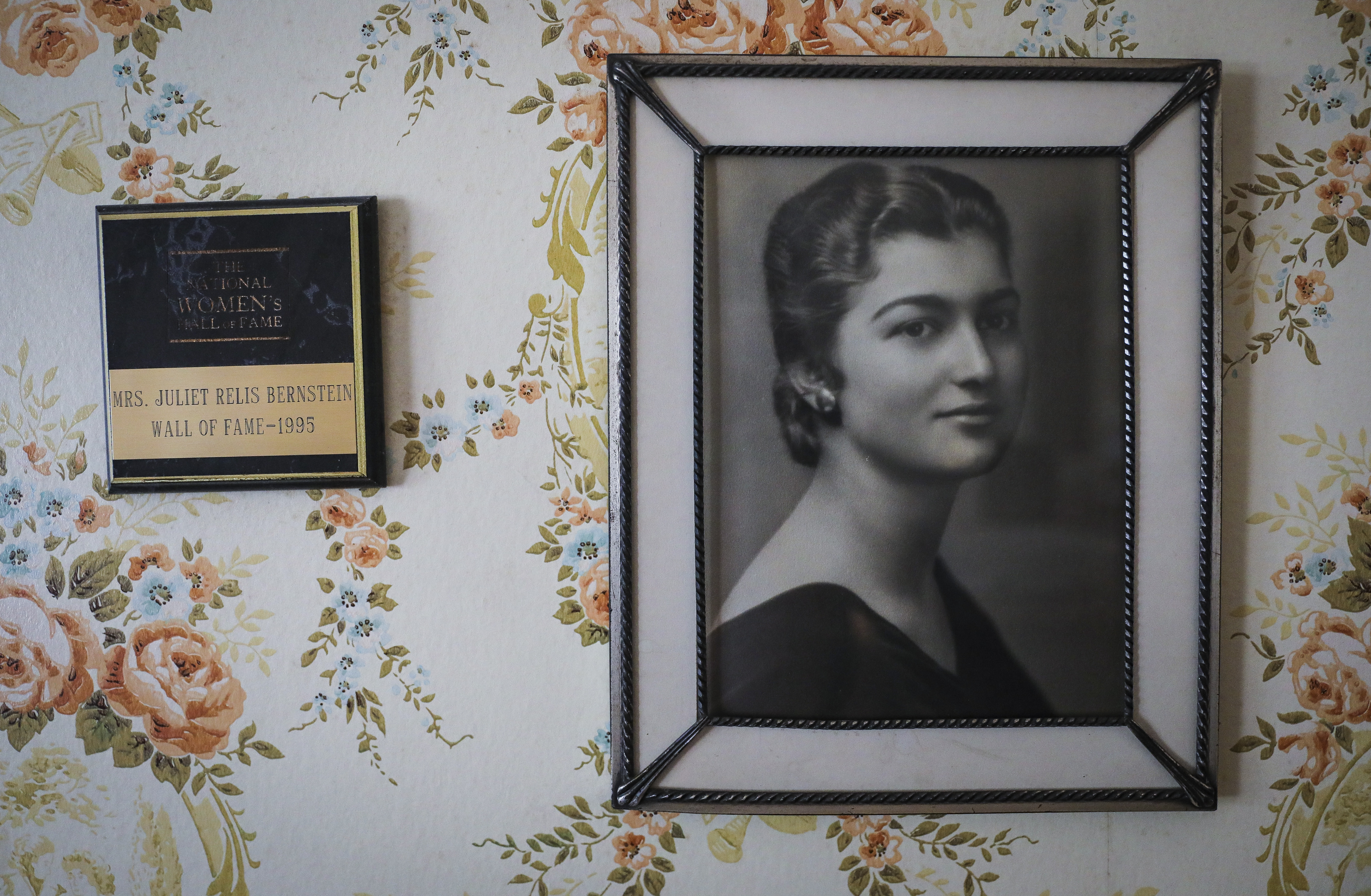 A portrait of Juliet Bernstein shortly after she graduated college is displayed in the bedroom of her Chatham home next to a National Women's Hall of Fame award, which Bernstein was awarded in 1995.