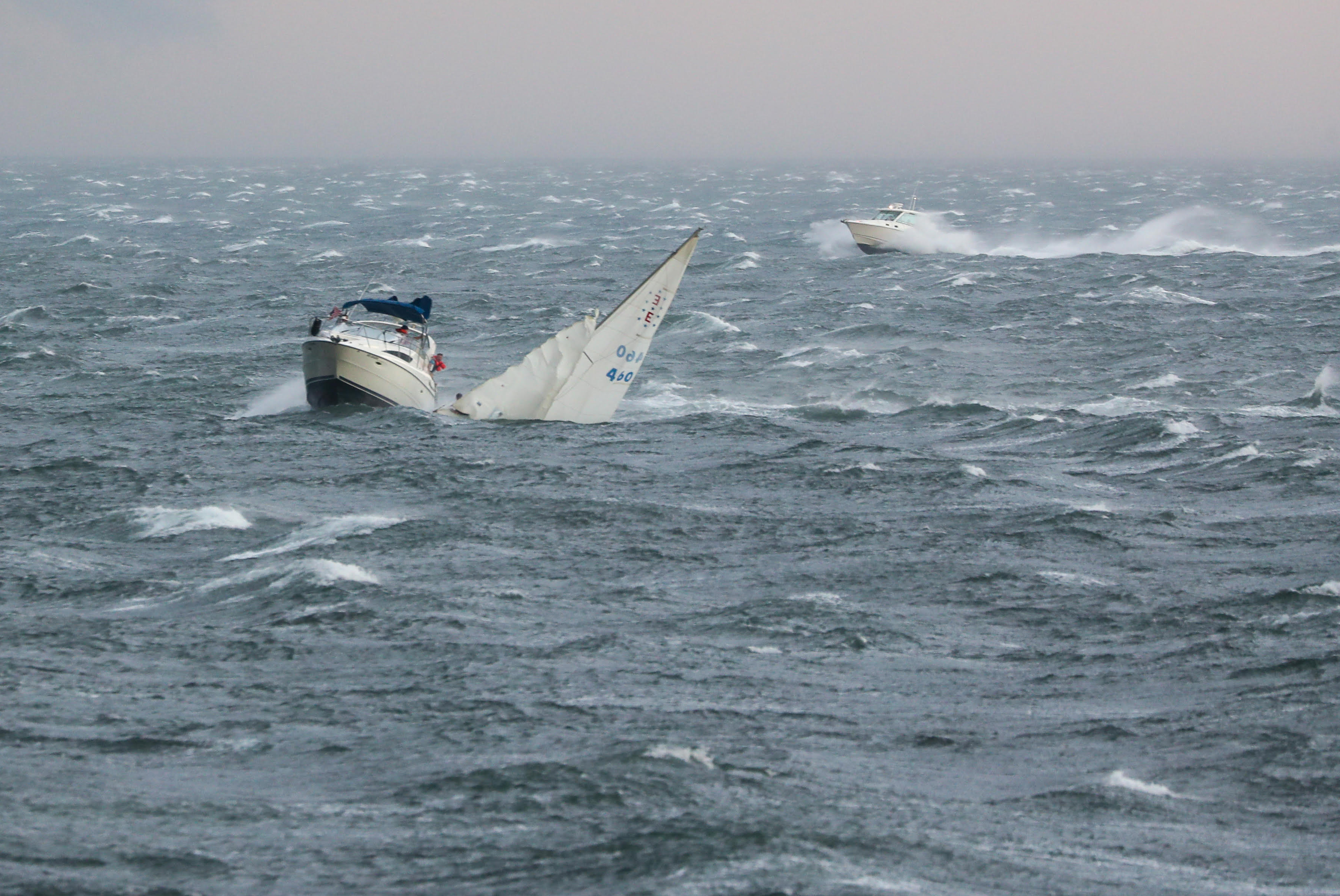 A storm ripped through Boston Harbor Sunday afternoon. The crew of an Ensign sailboat was rescued by a powerboat out of Quincy, named Reel Hustle.