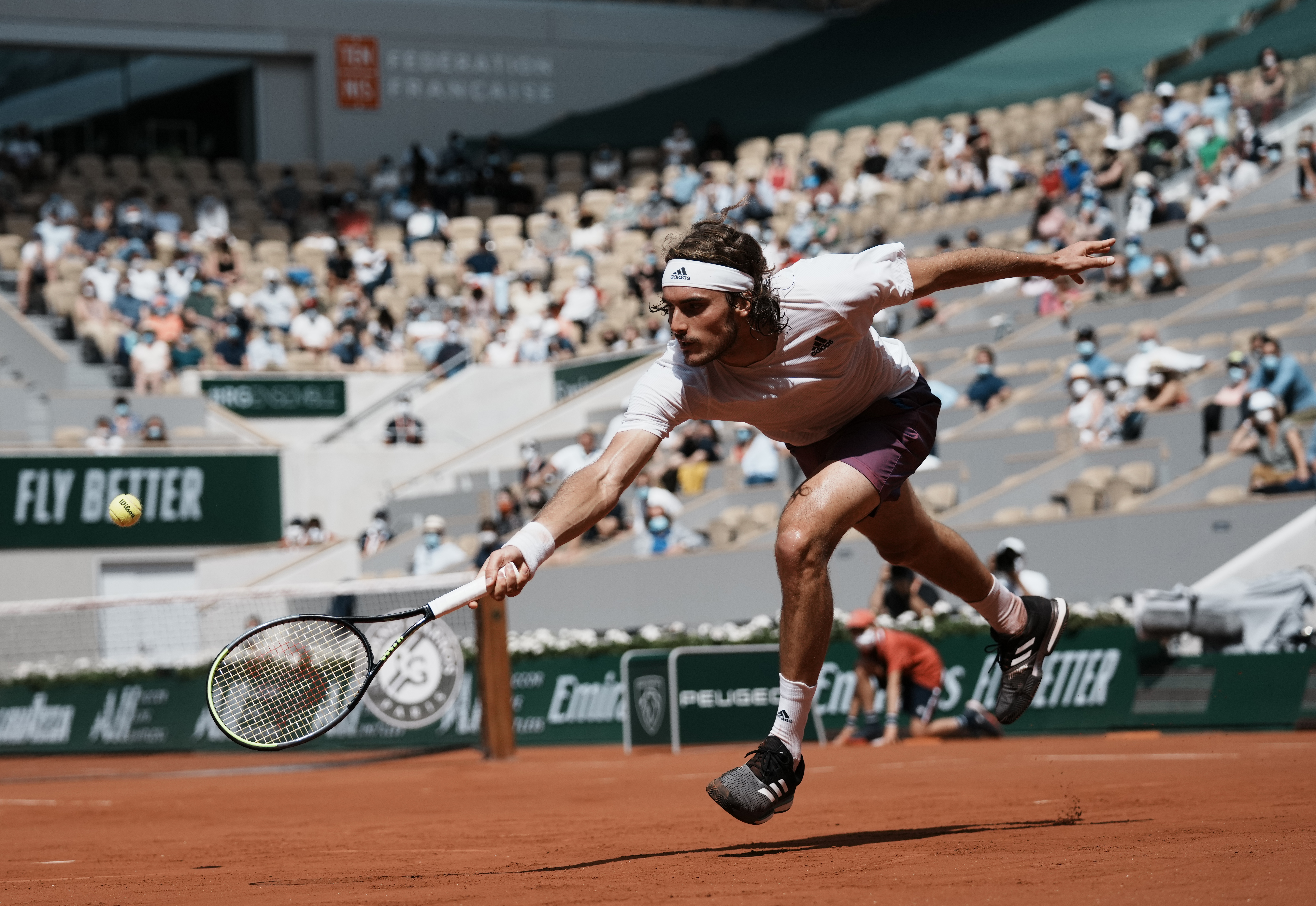Stefanos Tsitsipas plays a return against Pablo Carreno Busta during their fourth round match Sunday at the French Open.