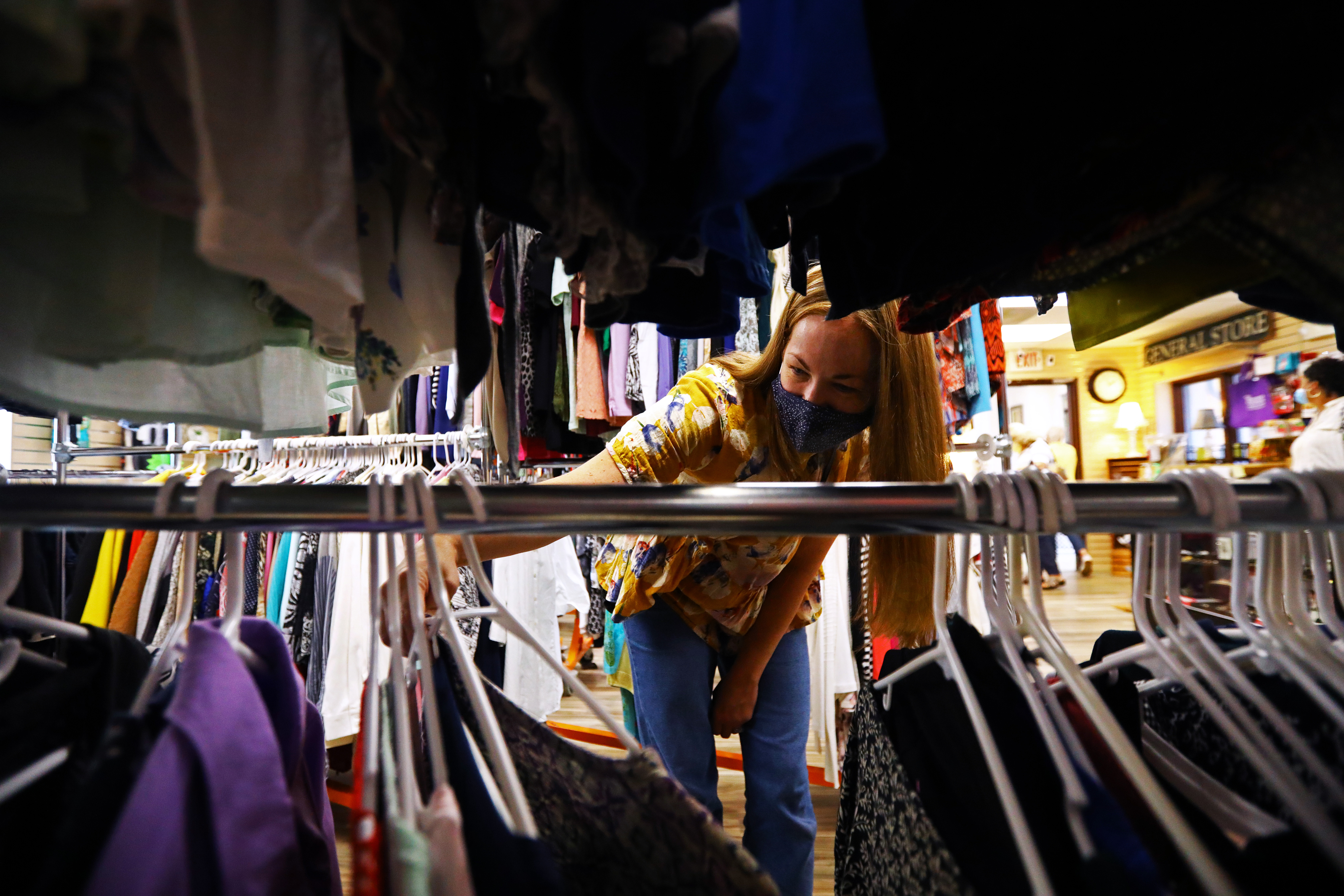 Lauren Lombard of Milton, is “looking for a good deal.”  Volunteers take in donations and shoppers browse at The Bureau Drawer Thrift Shop in Quincy.
