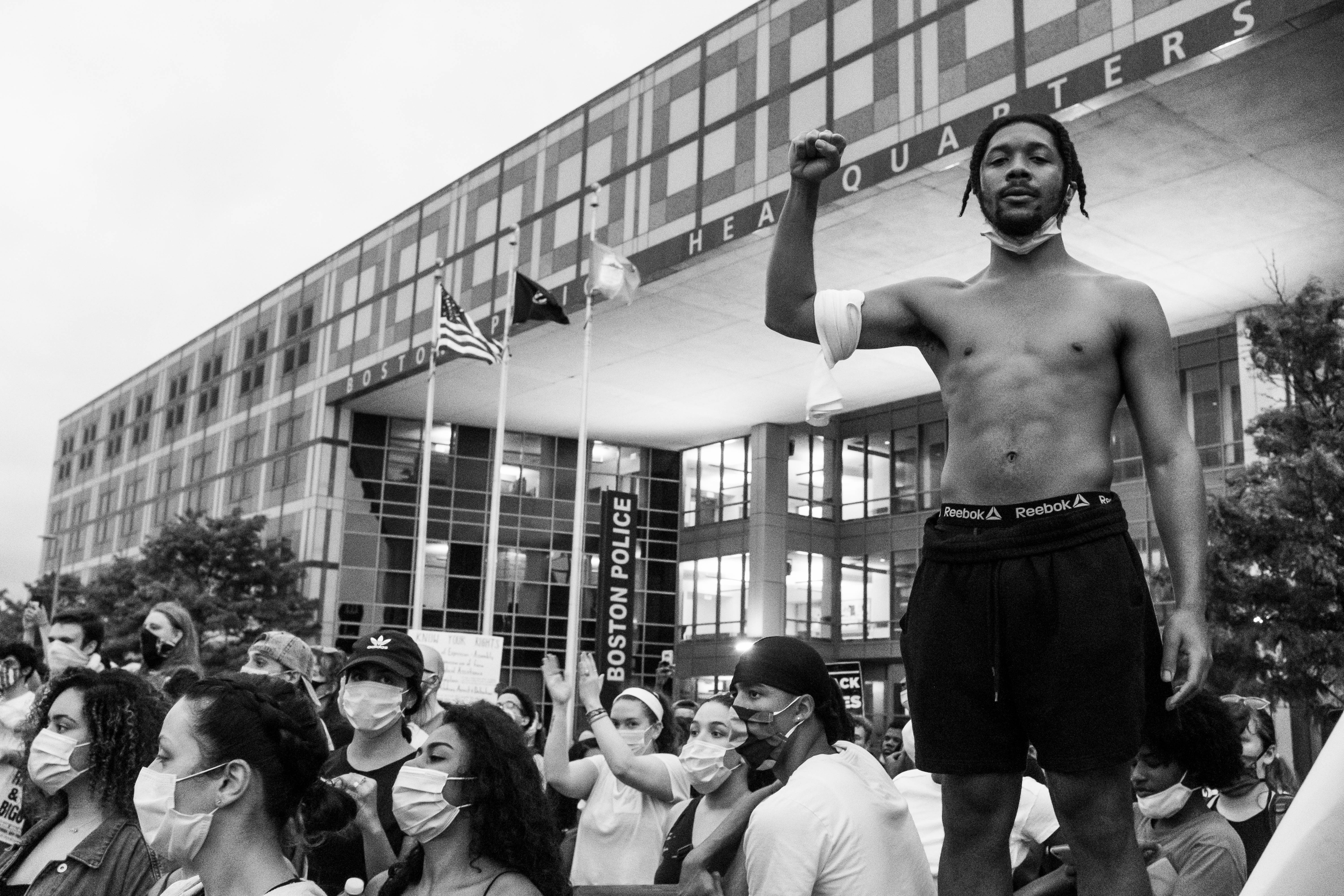 Harry Scales' photograph of "Young Man Raises the Revolutionary Fist" at Boston Police Headquarters on May 29.
