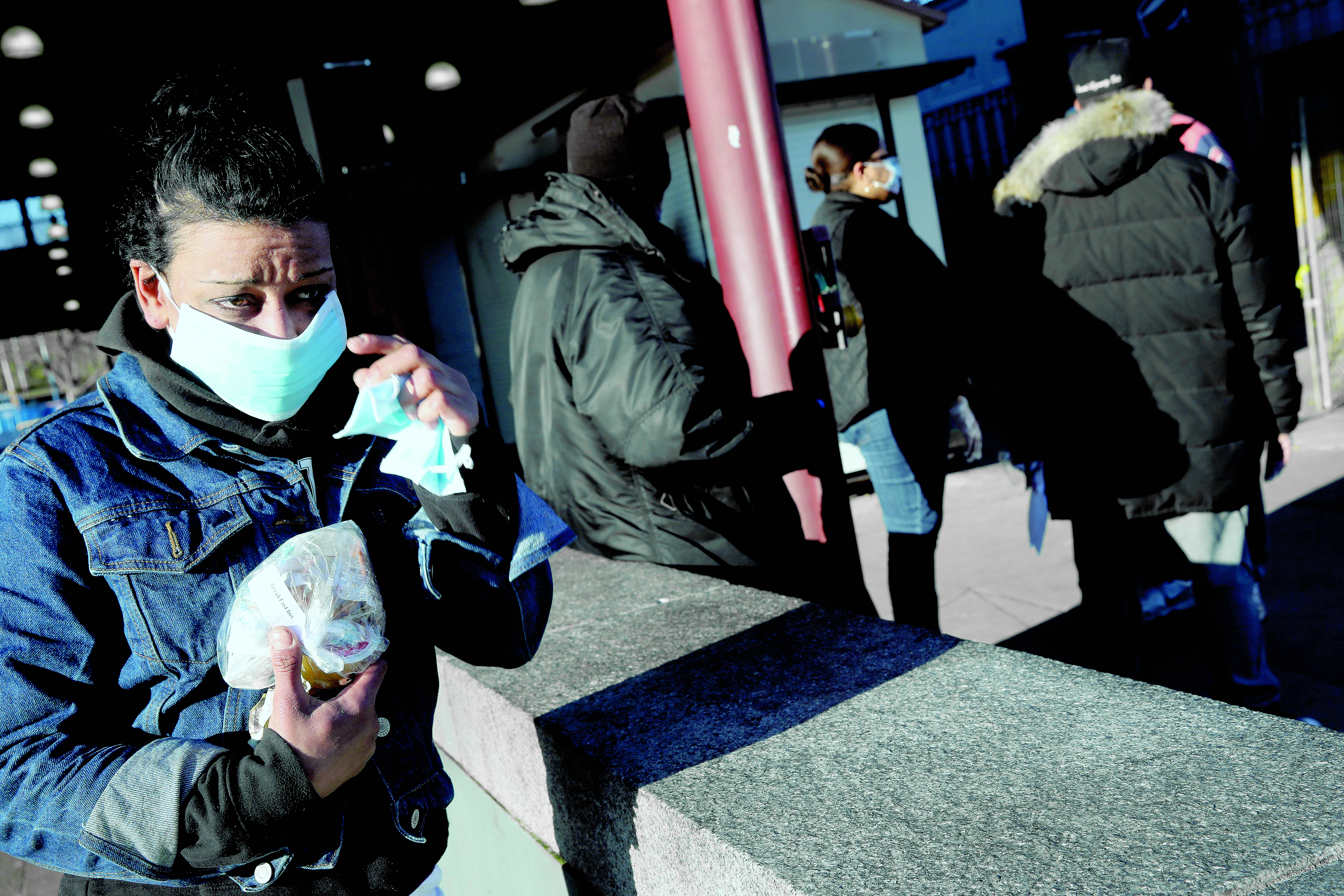 Boston, MA - 4/29/2020: Kerry Seerattan appreciated the new face mask she received while passing through Nubian Station in the Roxbury neighborhood of Boston, MA on April 29, 2020. Nubian Station is the largest bus station in the area serving a vast majority of riders, who are struggling financially due to the COVID-19 pandemic, which limits their access to adequate PPE. State Representative Chynah Tyler distributed face masks in partnership with a local business, “Just T” to constituents in transit to combat this issue. (Craig F. Walker/Globe Staff)