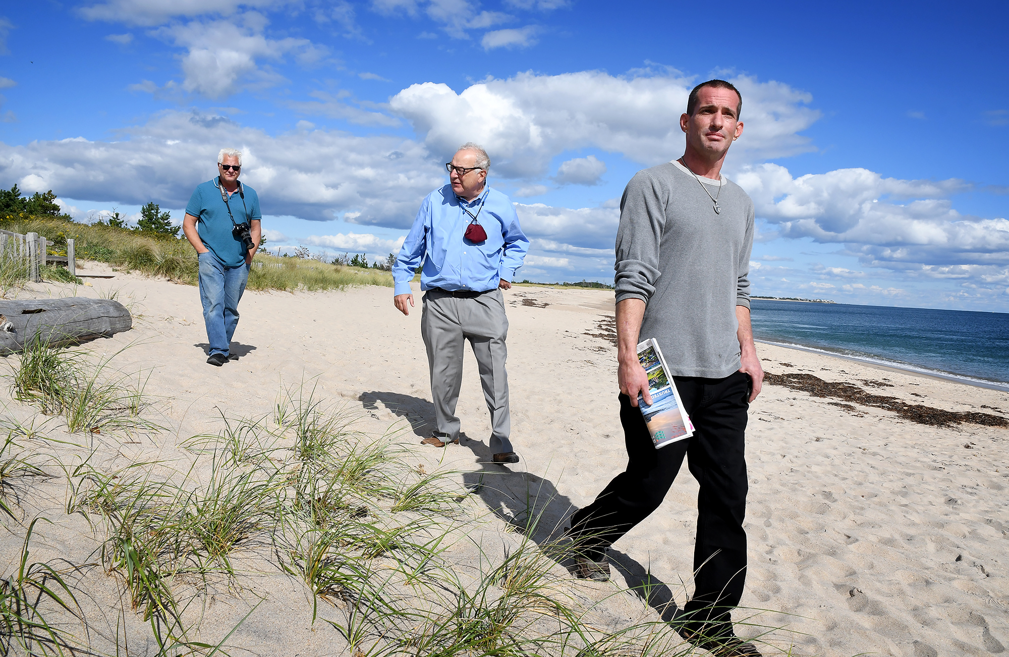 From left: Stephen Cersosimo, Michael Rubin and Ben Weber walk in the area of Spring Avenue Extension that was once a public right-of-way to Weekapaug Beach. A chain link fence was put in place they say in the early 1980s preventing public access.