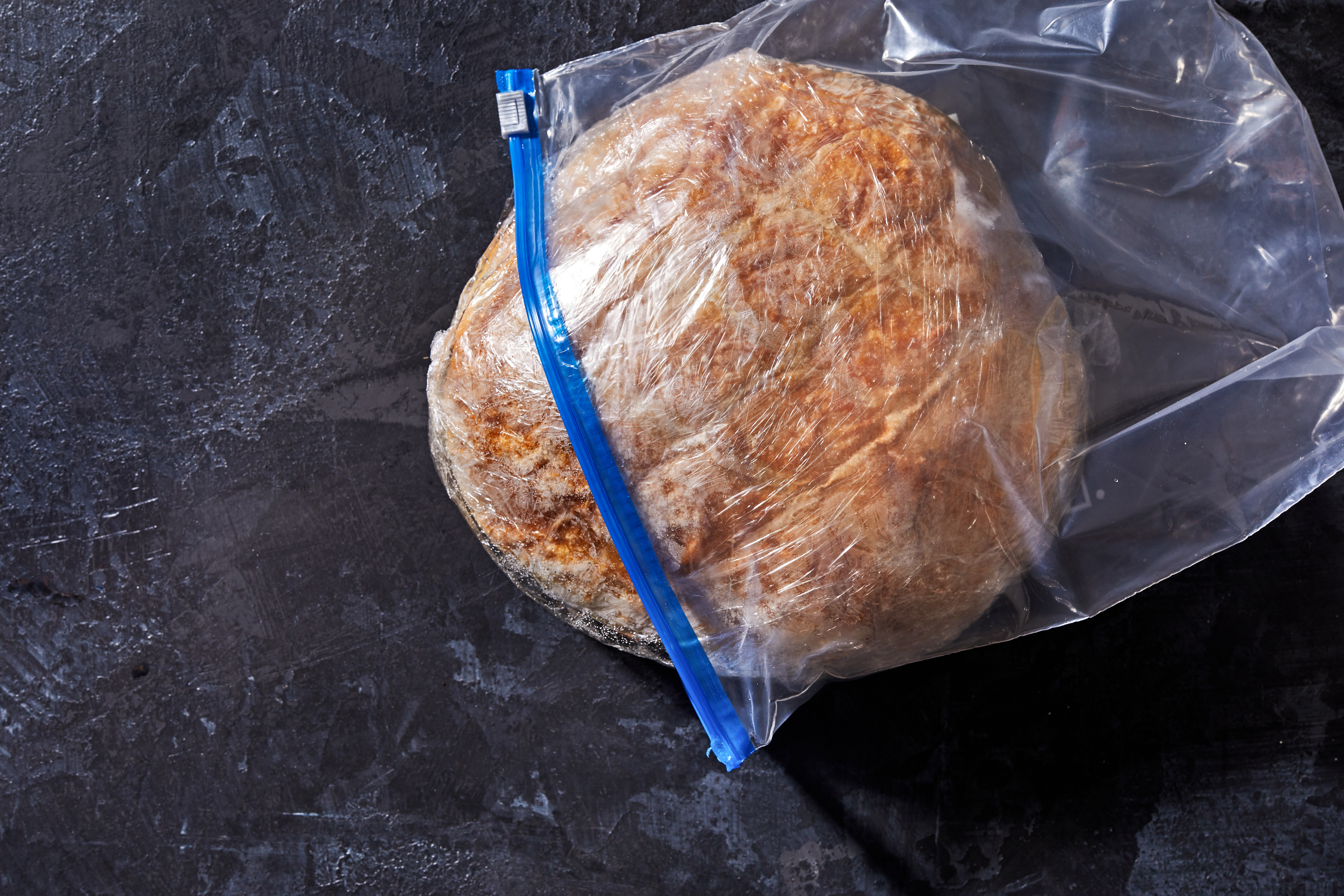 The easiest way to defrost a frozen loaf of bread is to place it, still wrapped, on the counter for a few hours or overnight, and then crisp it in a 350- to 400-degree oven for a few minutes.