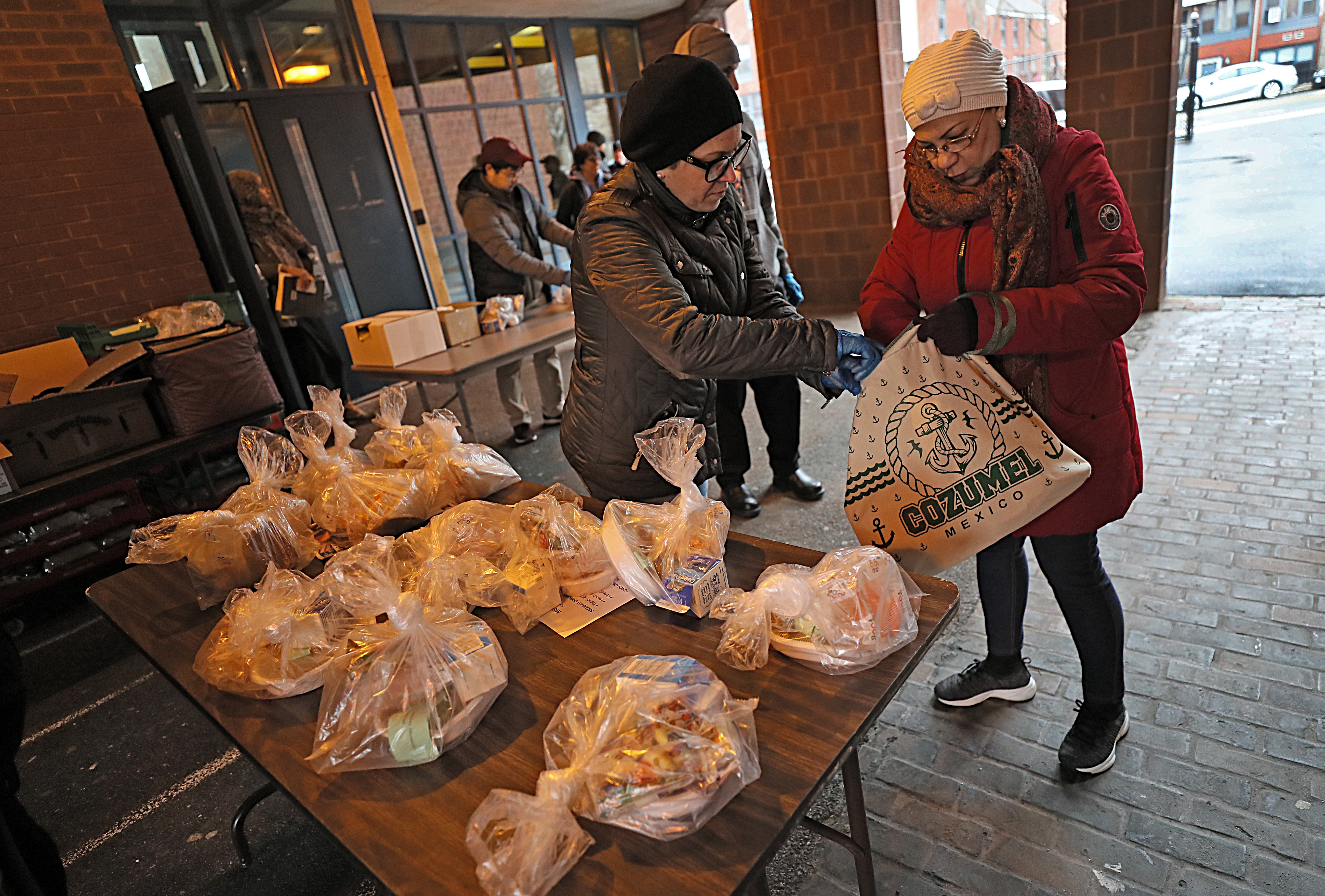 Amanda Lara (right) picked up lesson plans, breakfast, and lunch for her two grandchildren.