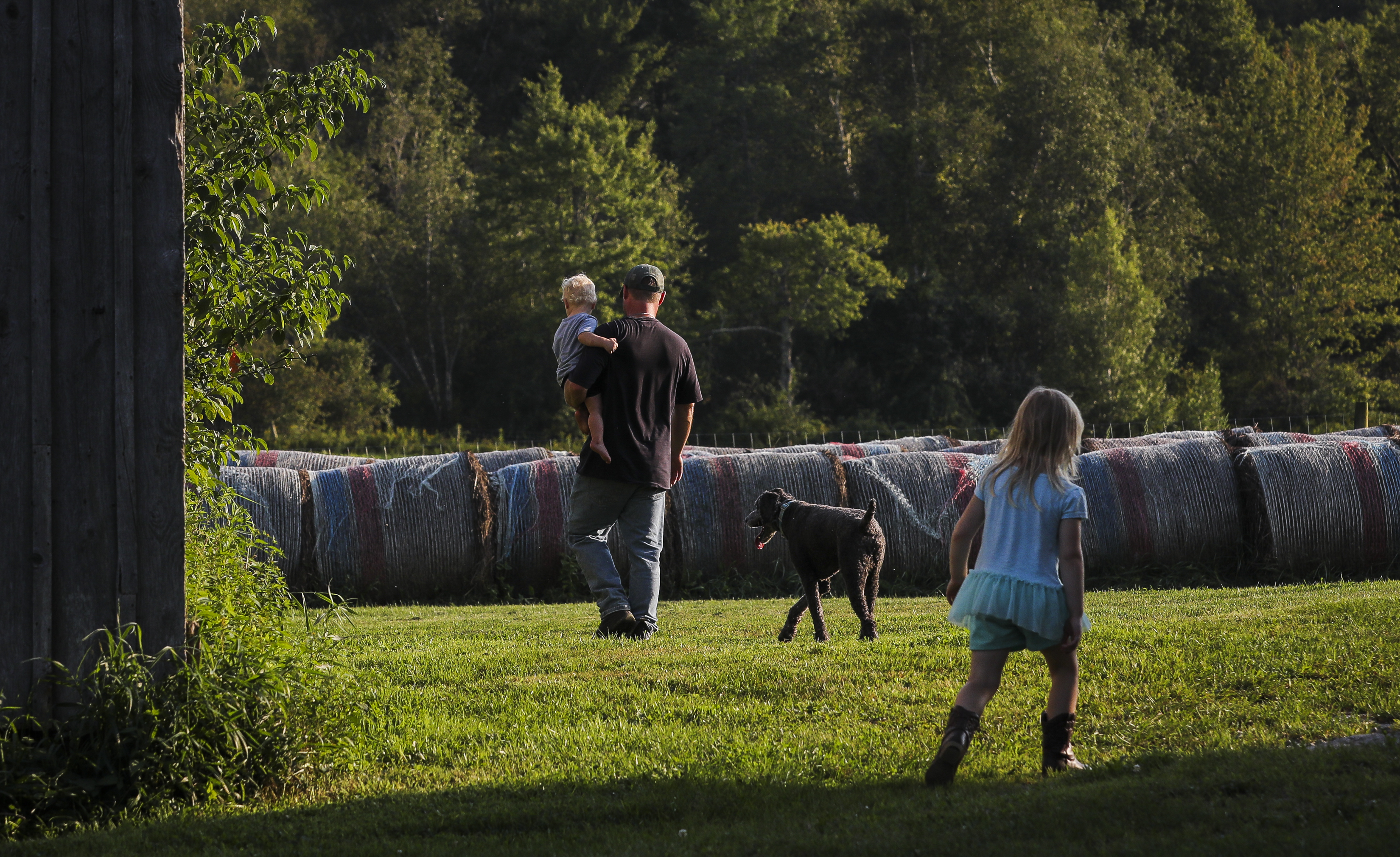 Darryl Lipinski holds son Cooley while his 5-year-old daughter, Nadia, walks nearby.