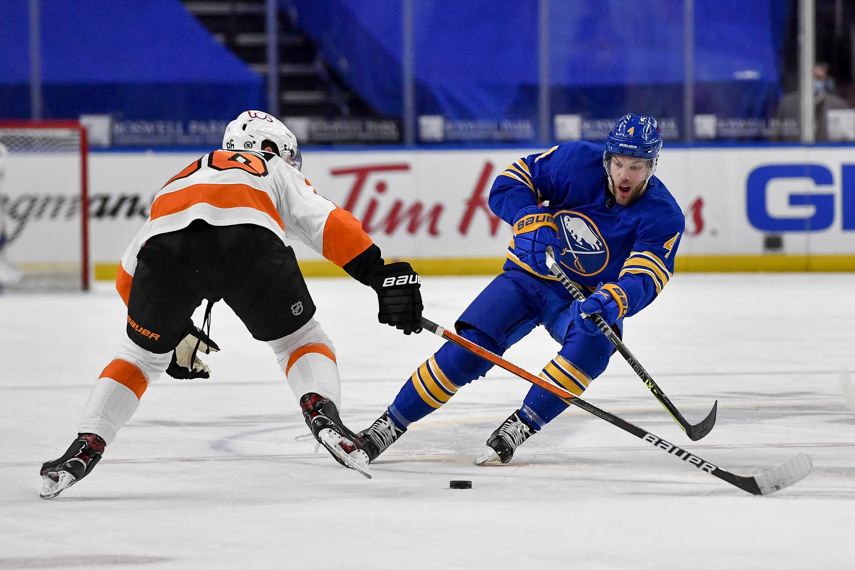 Taylor Hall passes the puck while pressured by Philadelphia's Joel Farabee during a game late last month.
