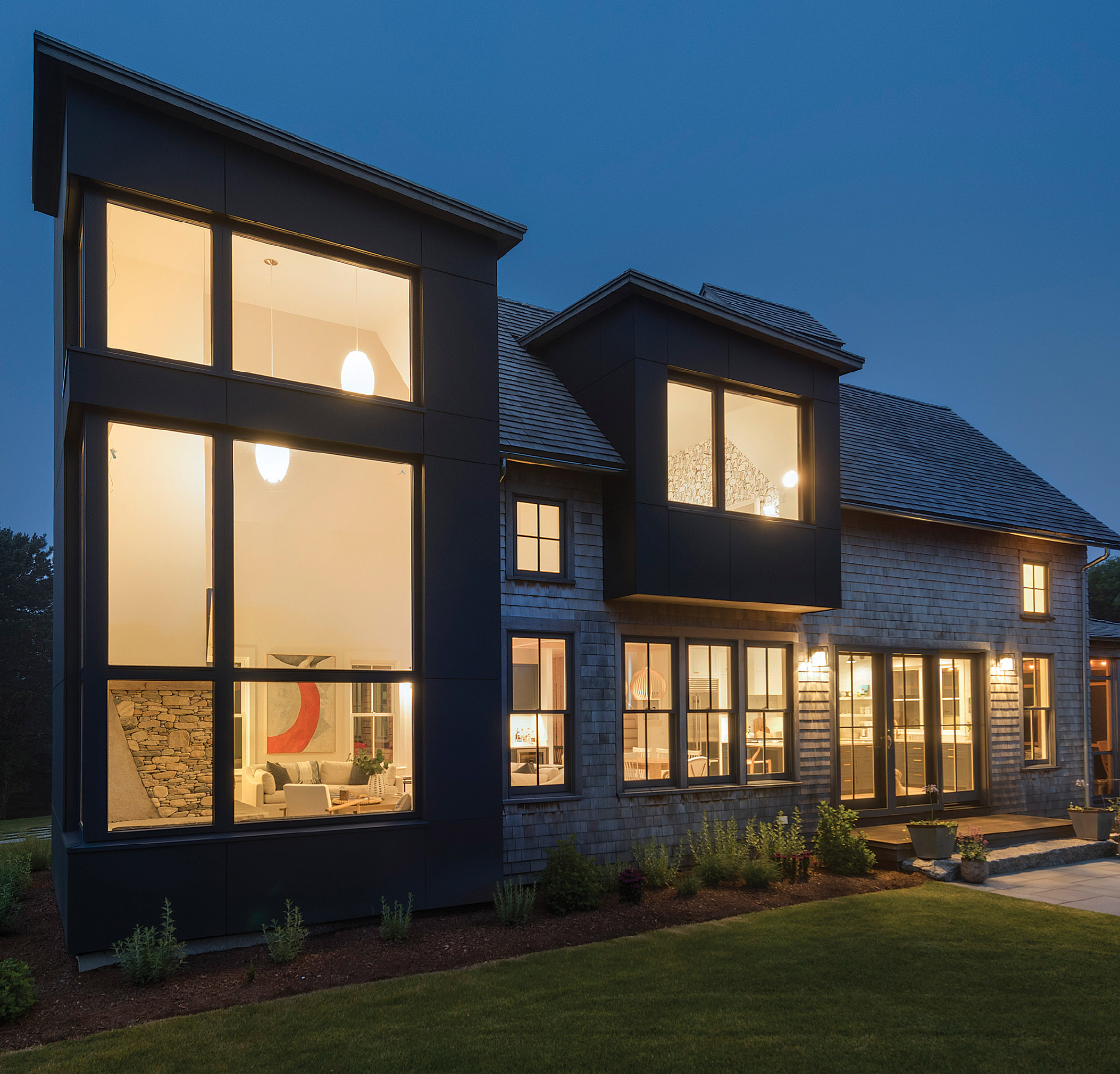 The tower and second-story bay window are clad in painted sheets of treated wood called Tricoya, which was easier to install than metal cladding.