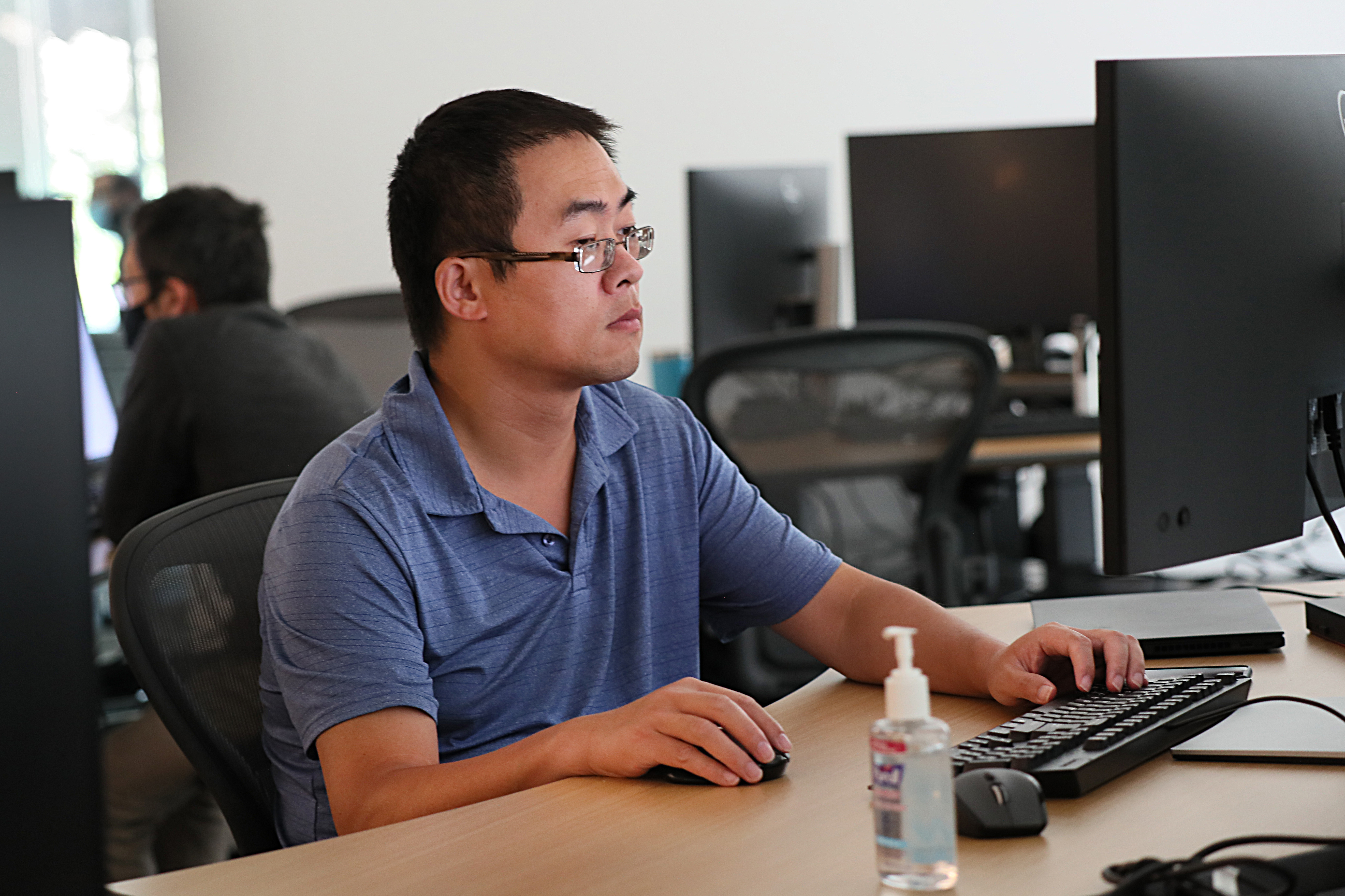 Yue Pan works at his desk at Relay Theraputics.