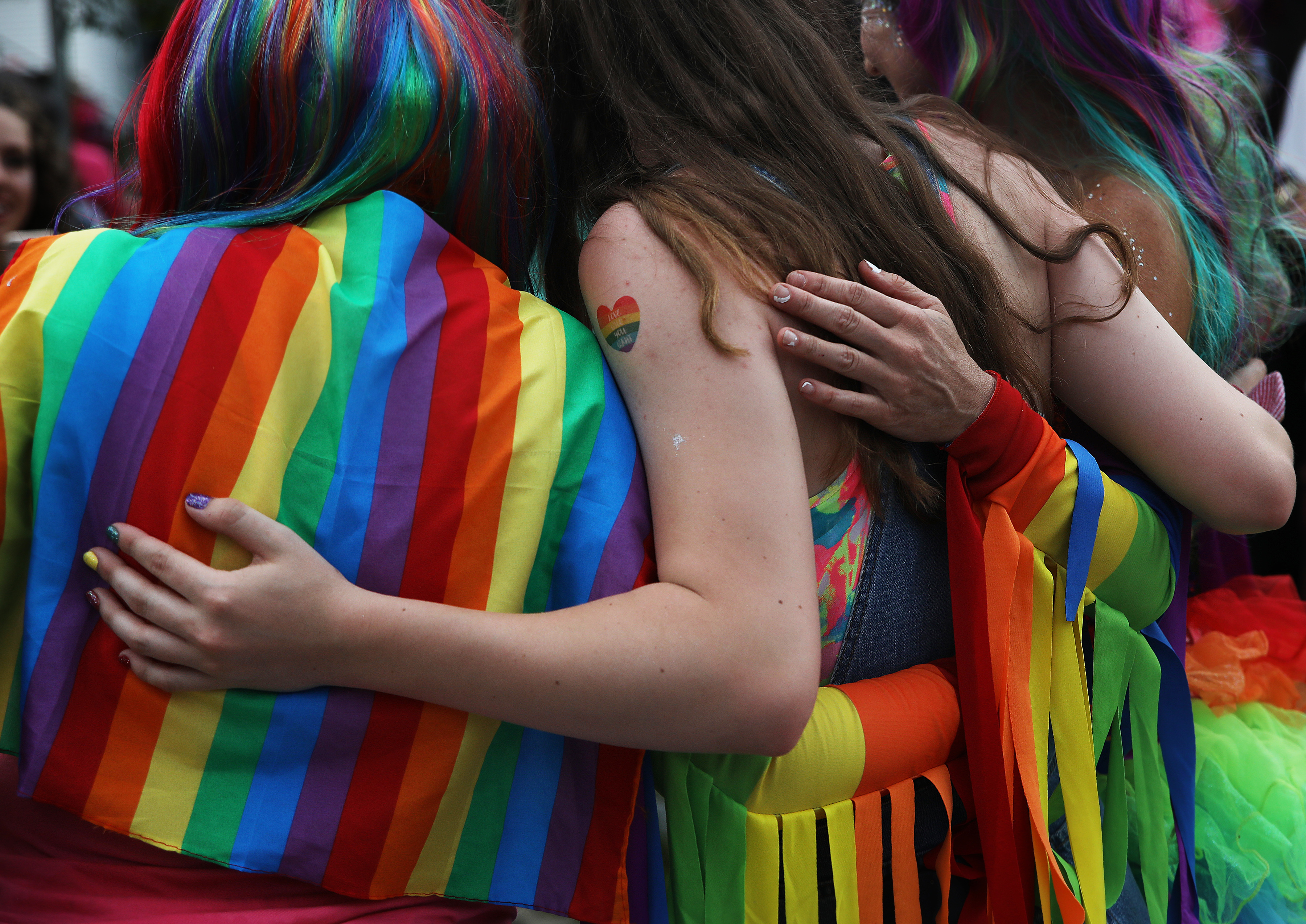 People embraced while taking a photo during the Nashua Pride festival on June 29. Attendees included Senator Bernie Sanders, Democratic candidate for president.