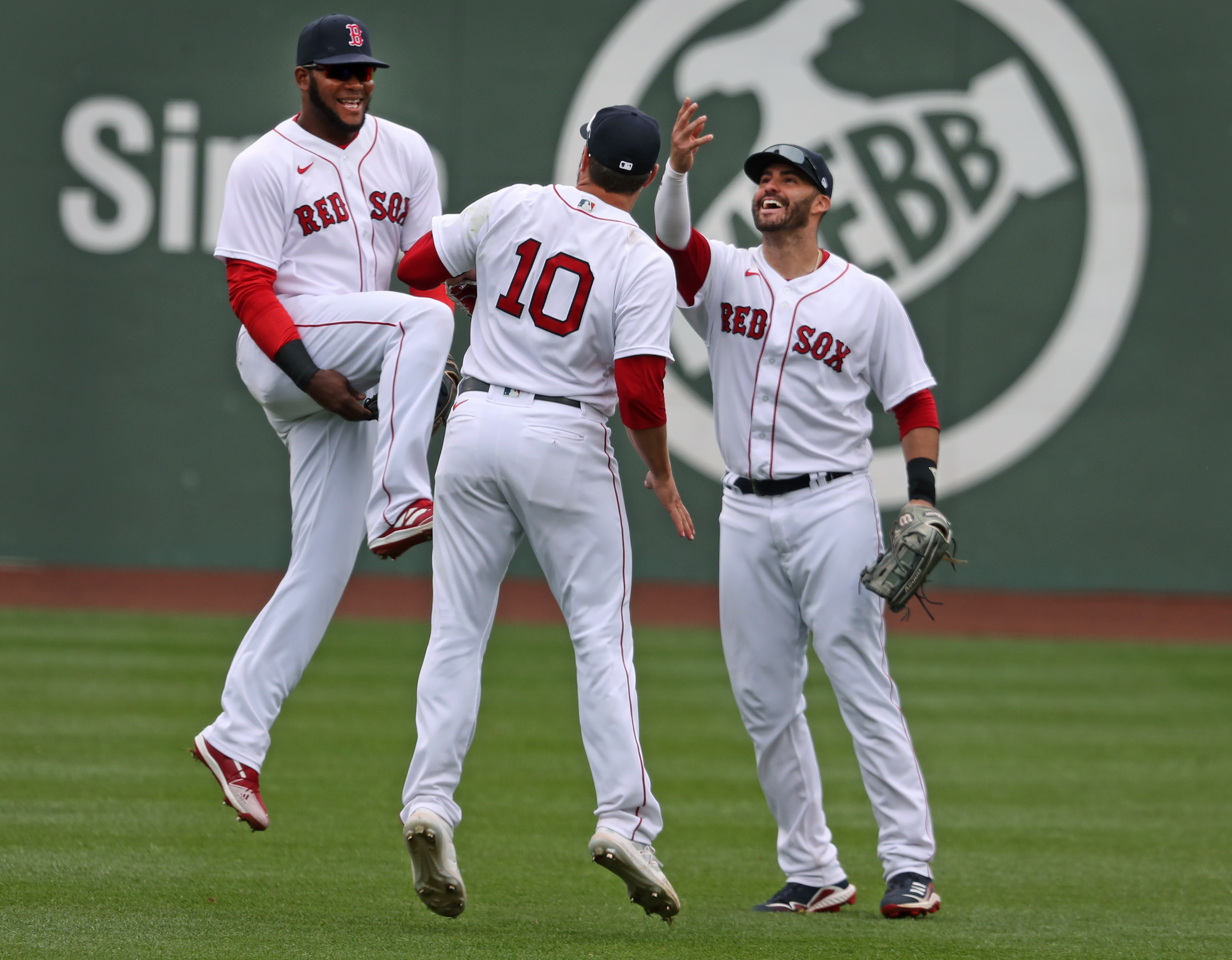 Franchy Cordero, Hunter Renfroe and J.D. Martinez celebrate after the final out in Boston's 9-2 win over Tampa Wednesday.