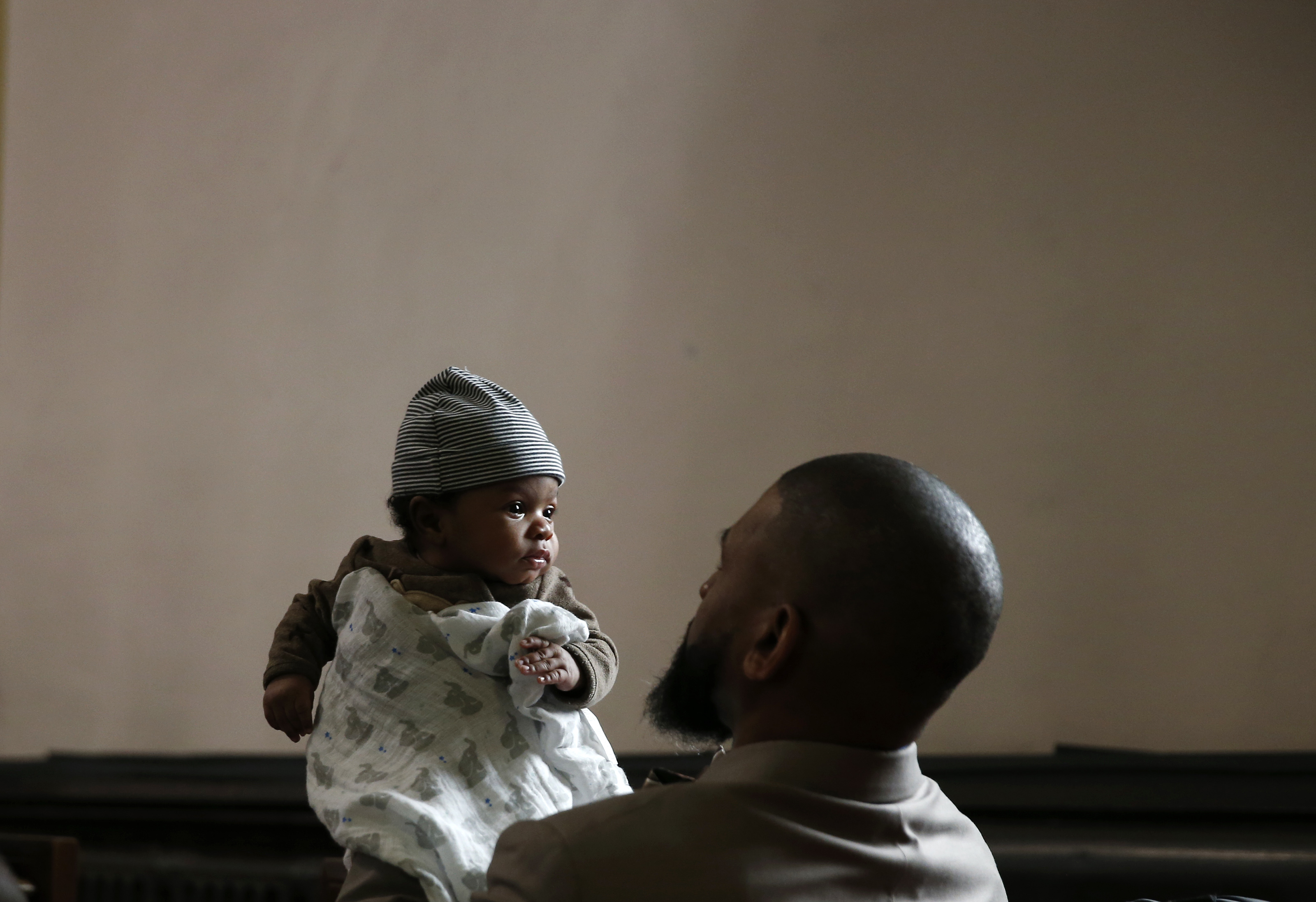 Marcus Bowden of Mattapan held his two-month-old great newphew during a Sunday service at Eliot Congregational Church of Roxbury.