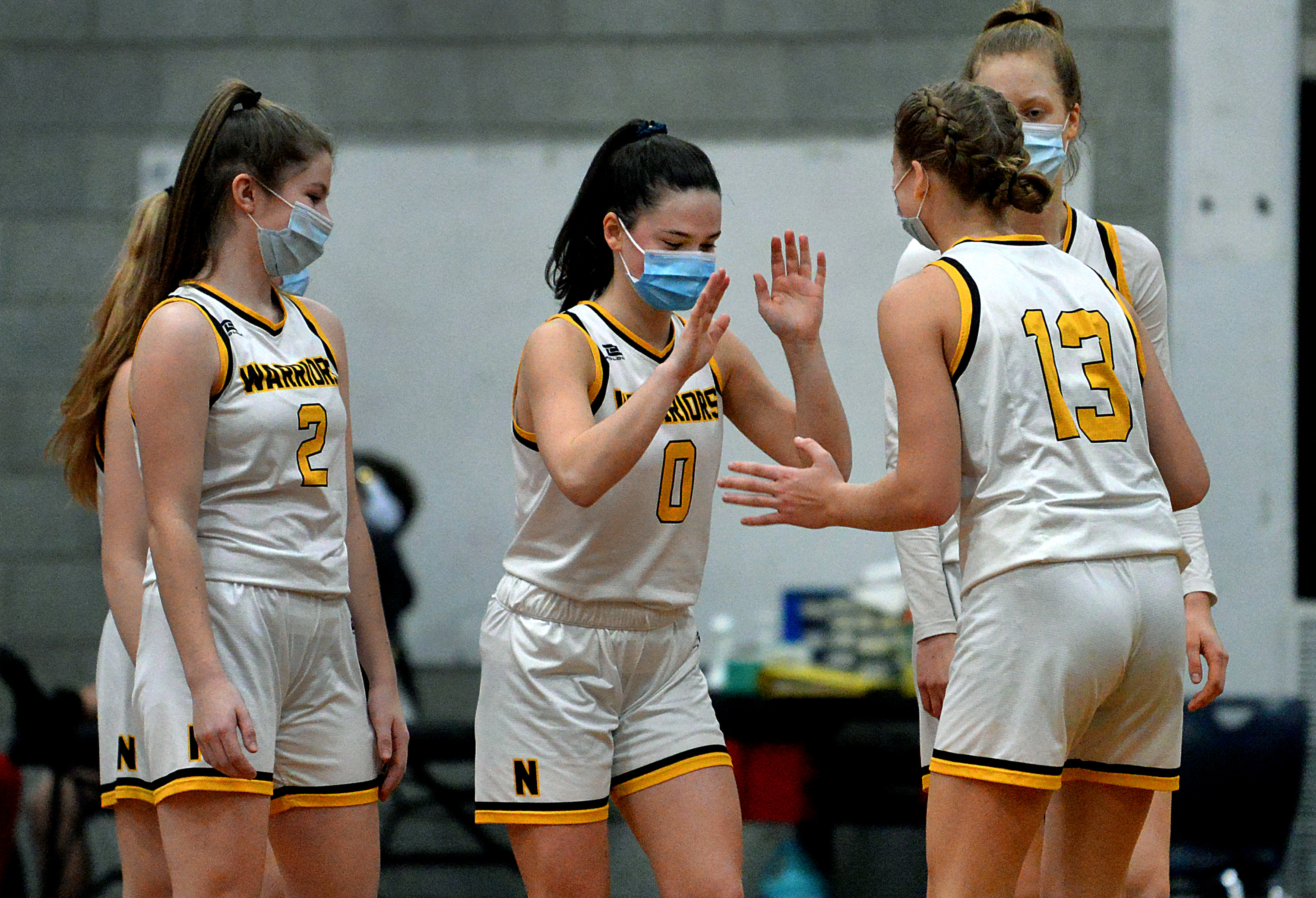 Avery Burns (0) fires up her Nauset teammates before they take the court for the start of the fourth quarter against Nantucket.