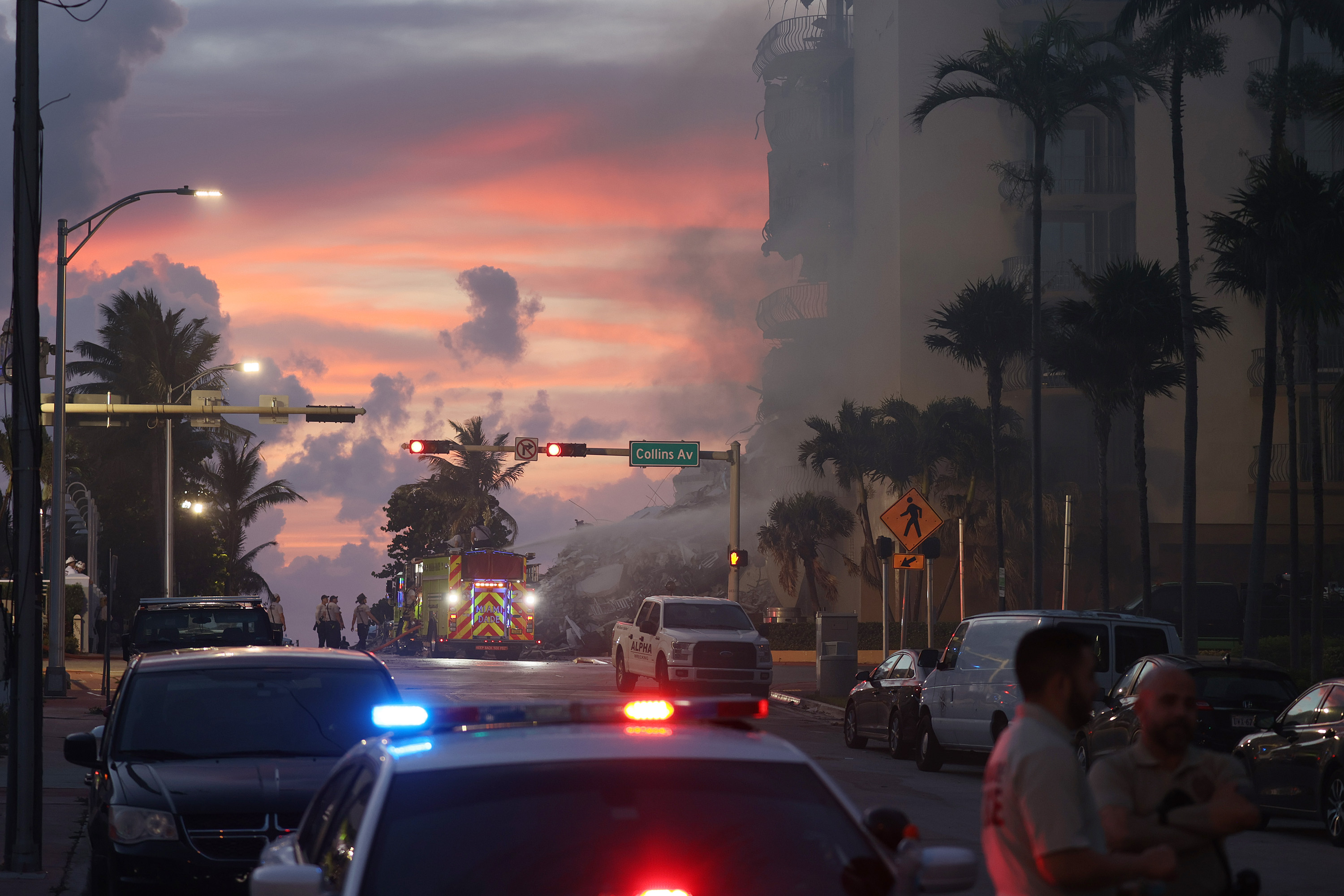 Miami-Dade Fire Rescue personnel sprayed water on a fire in the partially collapsed condo building as search and rescue operations continued Friday.