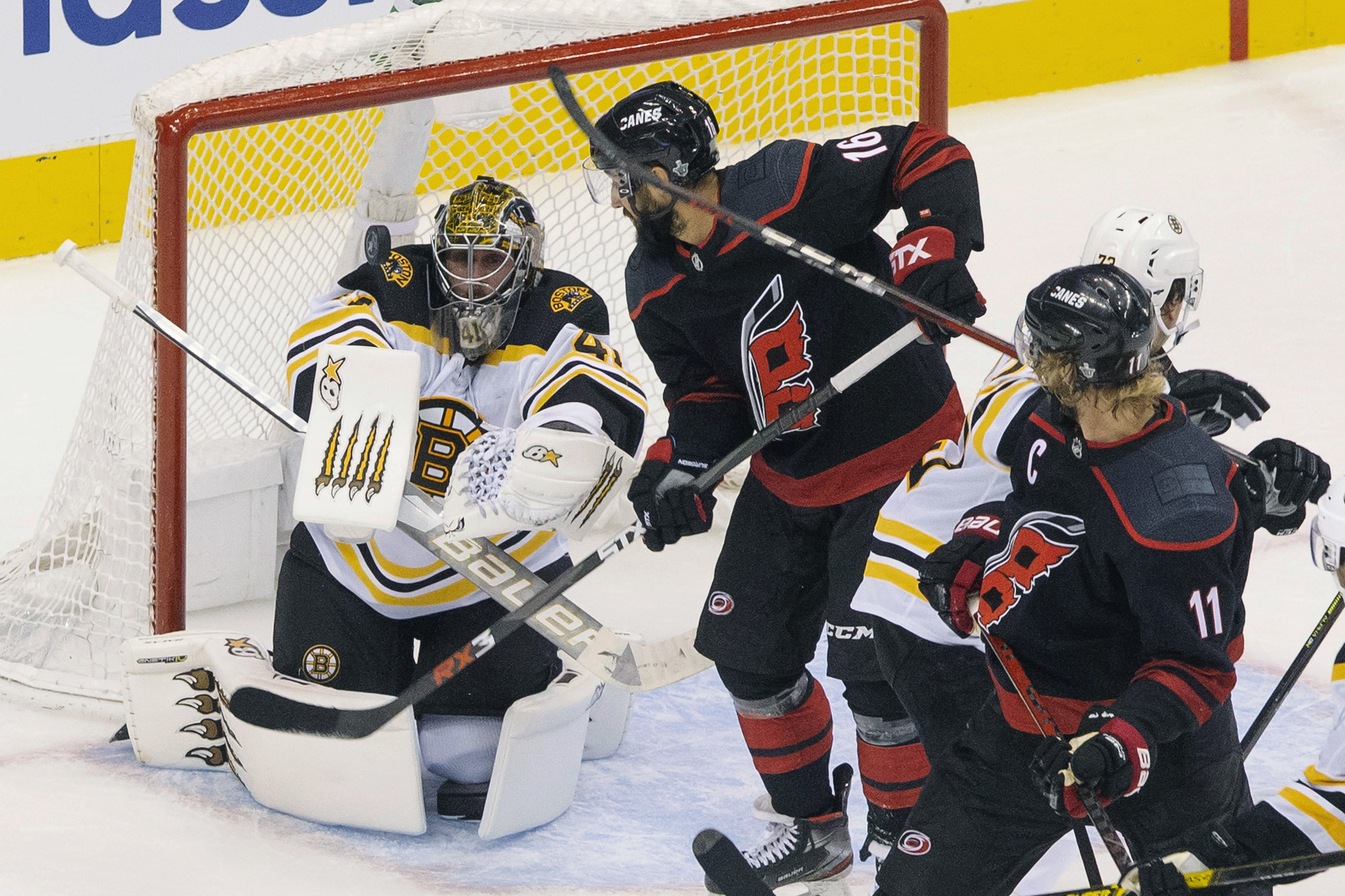 Jaroslav Halak eyes the puck in front of Carolina's Vincent Trocheck (16) in the third period of Saturday's game.