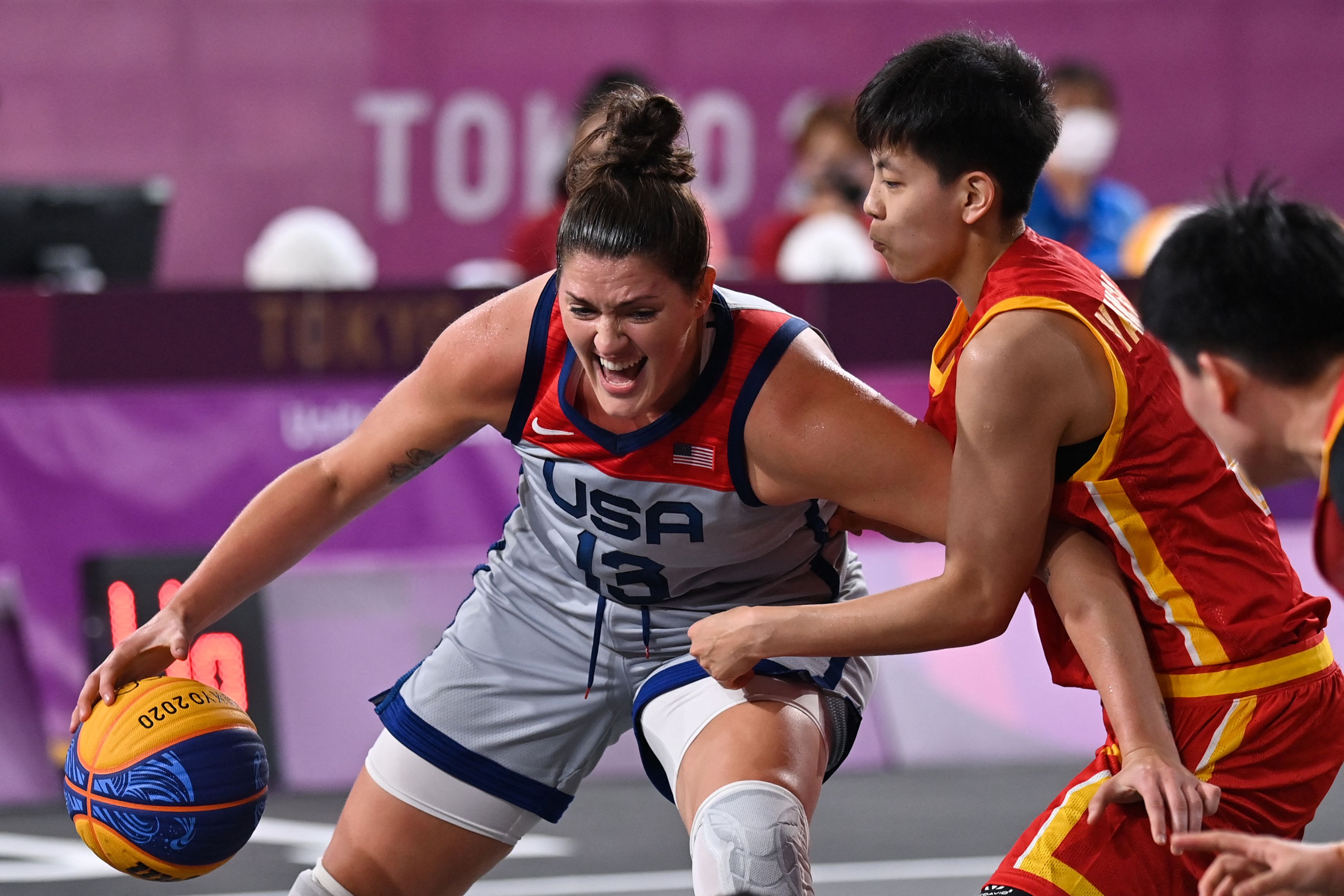 Stefanie Dolson of the US (left) is defended by China's Yang Shuyu during pool play of the women's 3x3 basketball competition.