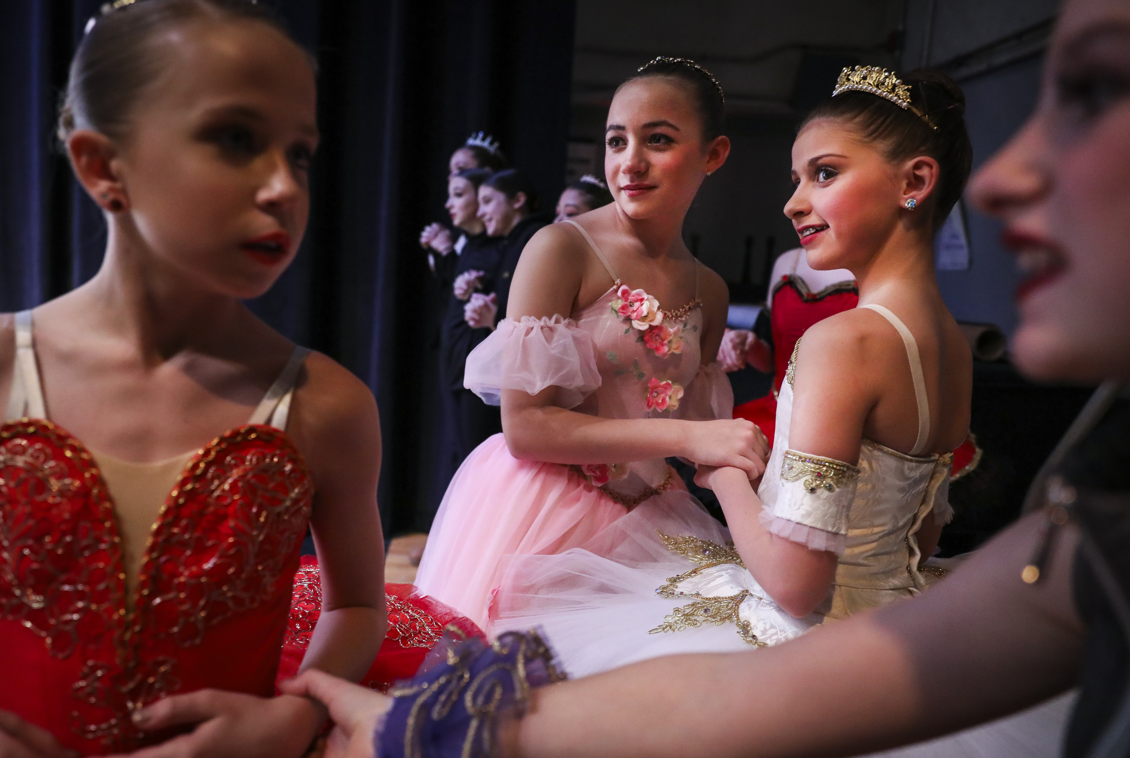 Ballet dancers Maya Minella, 12, left, and Sydney Laganza, 12, held hands in anticipation as their friend completed her routine in the junior classical competition category while competing in the Youth America Grand Prix in Boston on March 6.