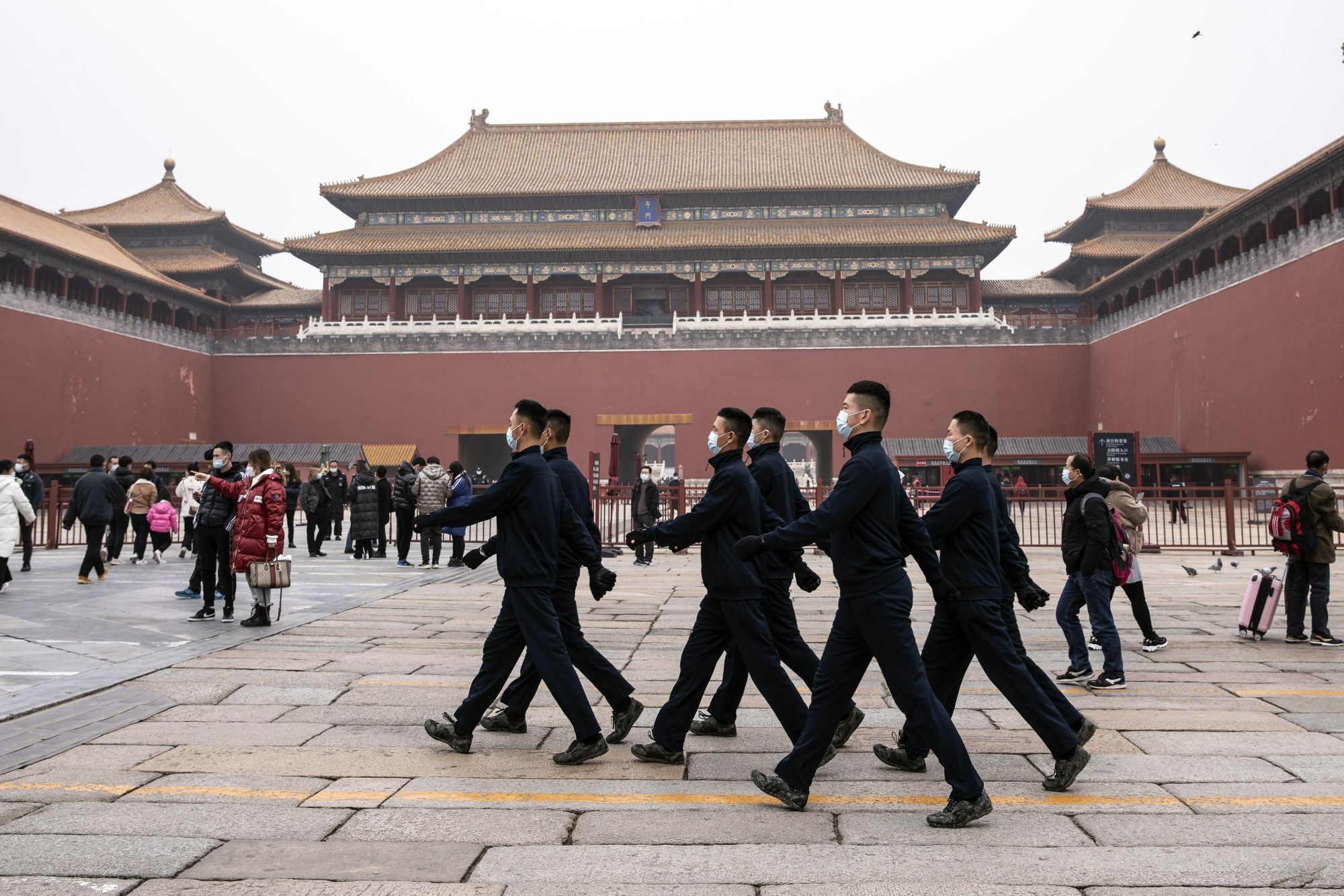 Members of the People's Liberation Army (PLA) honor guard in plain clothes march through the Forbidden City in Beijing, China.
