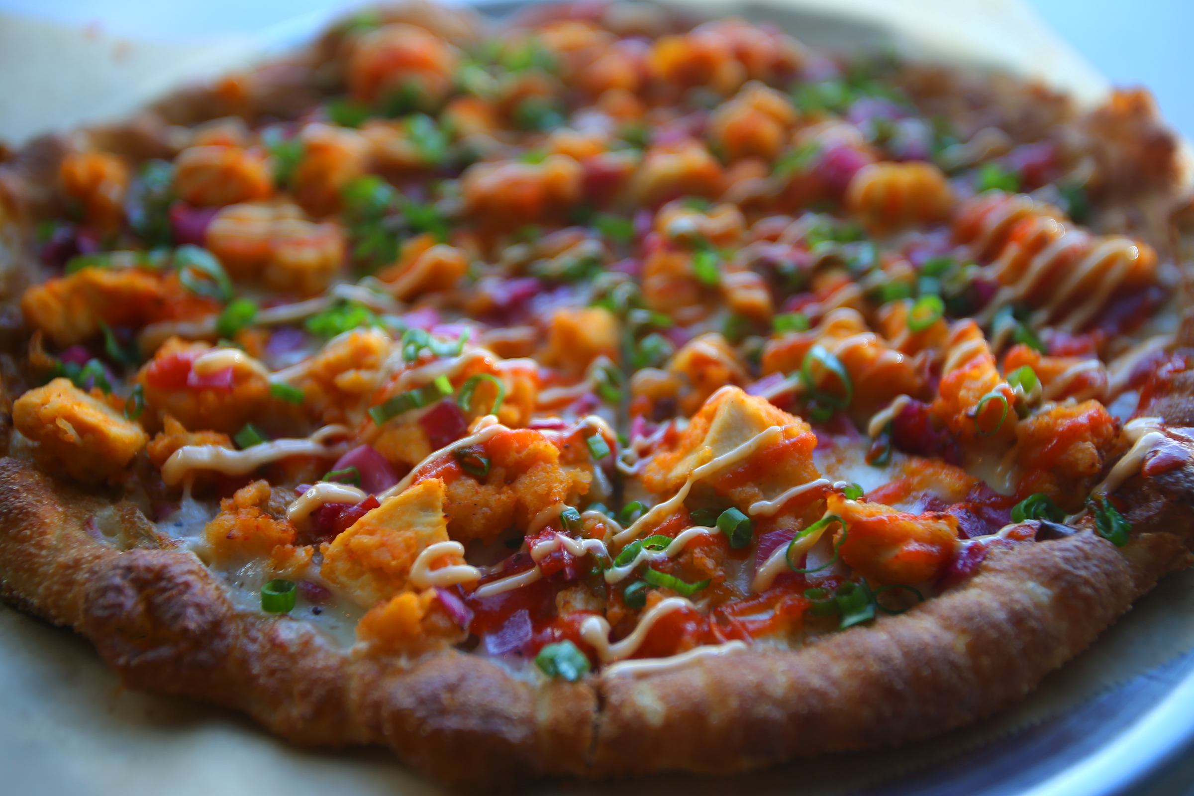 A pizza with sriracha sauce at the Chestnut Hill location of Oath, a craft pizzeria.