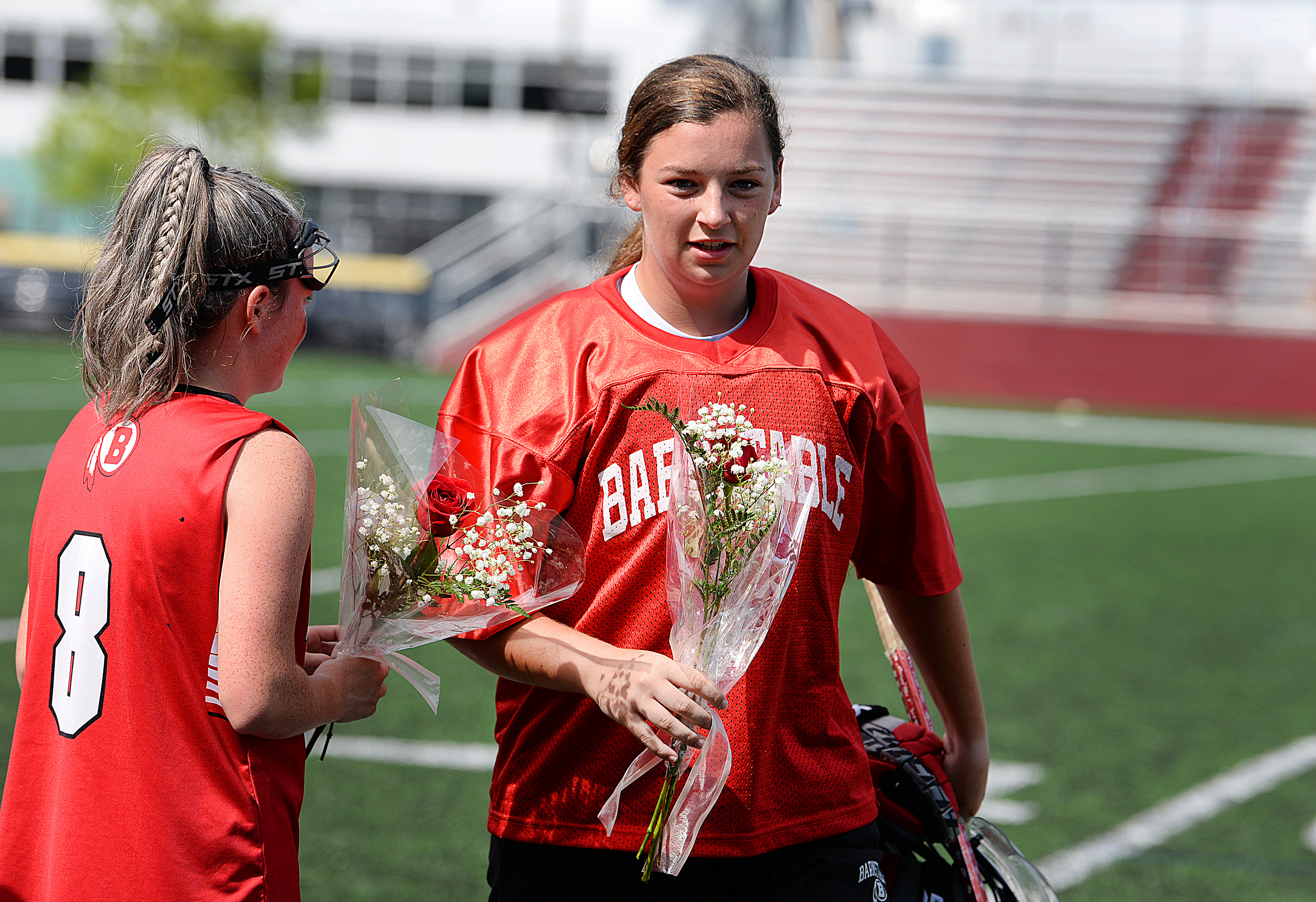 Barnstable goalie Morgan Dardia (right) and fellow senior captain Heather Hanson (left), are presented with roses before their recent Senior Day game vs. Falmouth. “She keeps our team going when we start to get down," Hanson said of Dardia, her best friend.