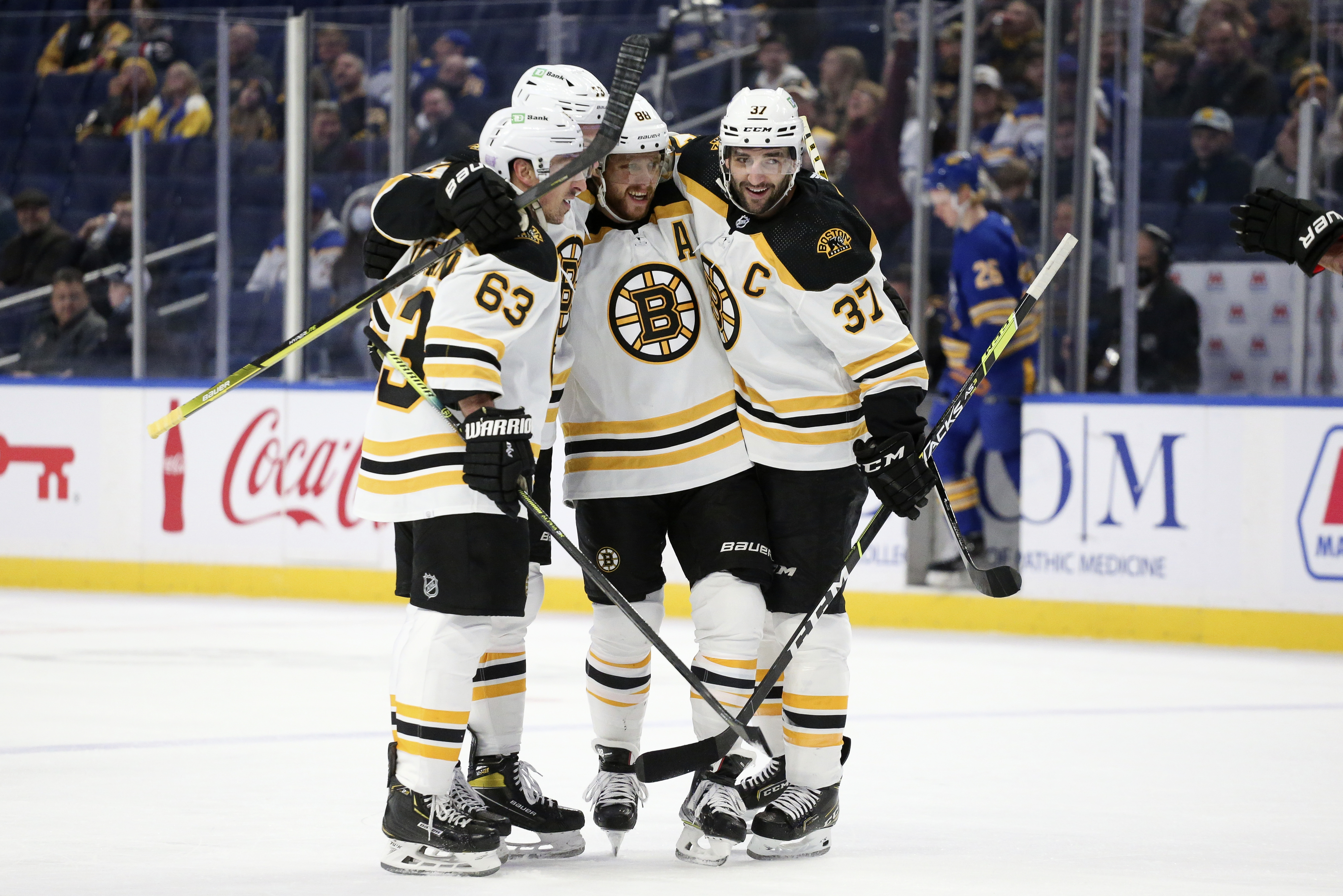 Brad Marchand, Charlie McAvoy, David Pastrnak and Patrice Bergeron celebrate Pastrnak's first-period goal Wednesday night in Buffalo.