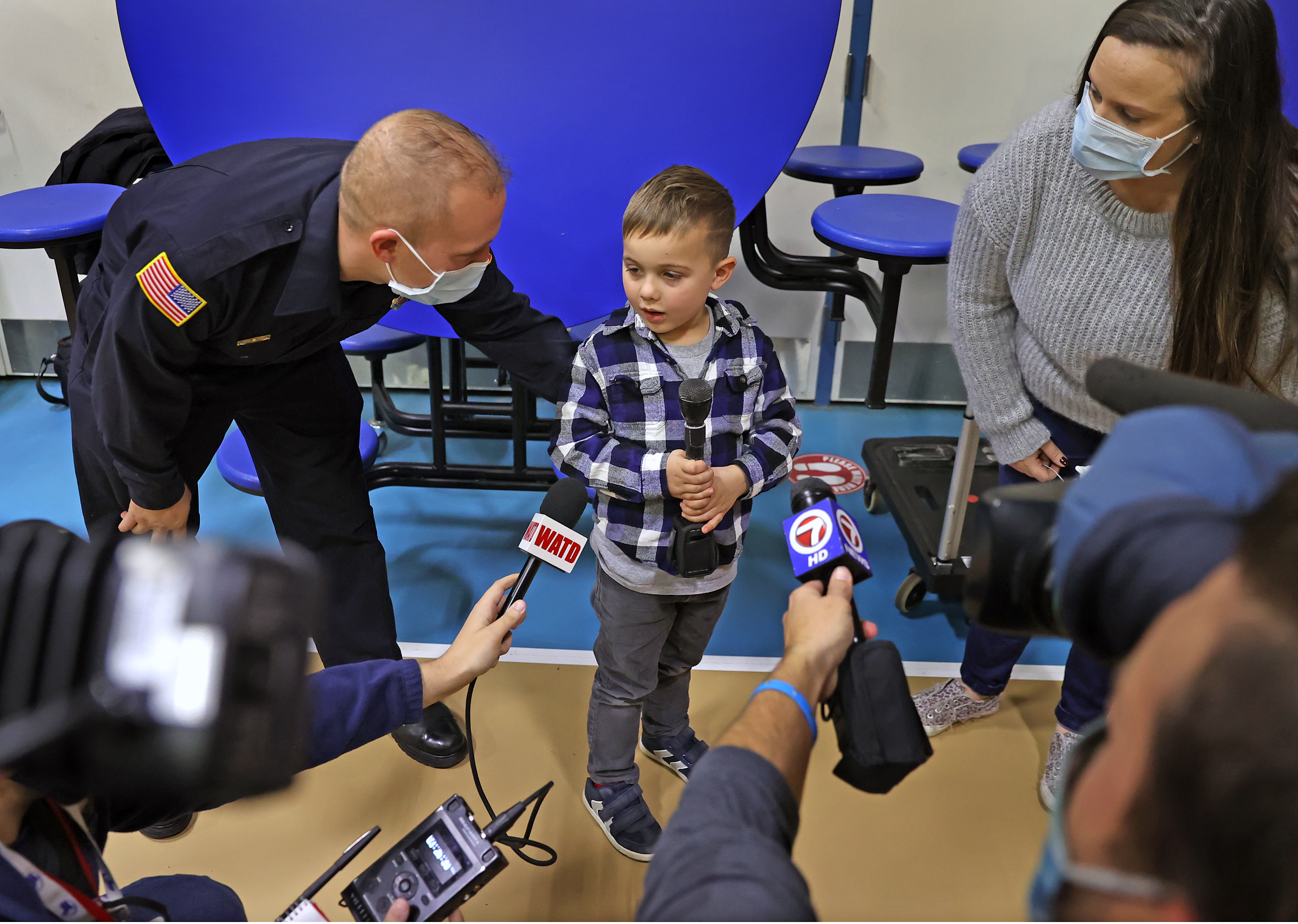Plympton firefighter Steve Galambos and his son, Cayden Galambos, give an interview to reporters Wednesday.